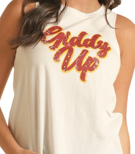 A woman wears a sleeveless white Rock & Roll Denim Giddy Up Graphic Tank Top, featuring bold red and yellow script across the chest—ideal for rodeo and western culture fans. Only her upper body is shown.