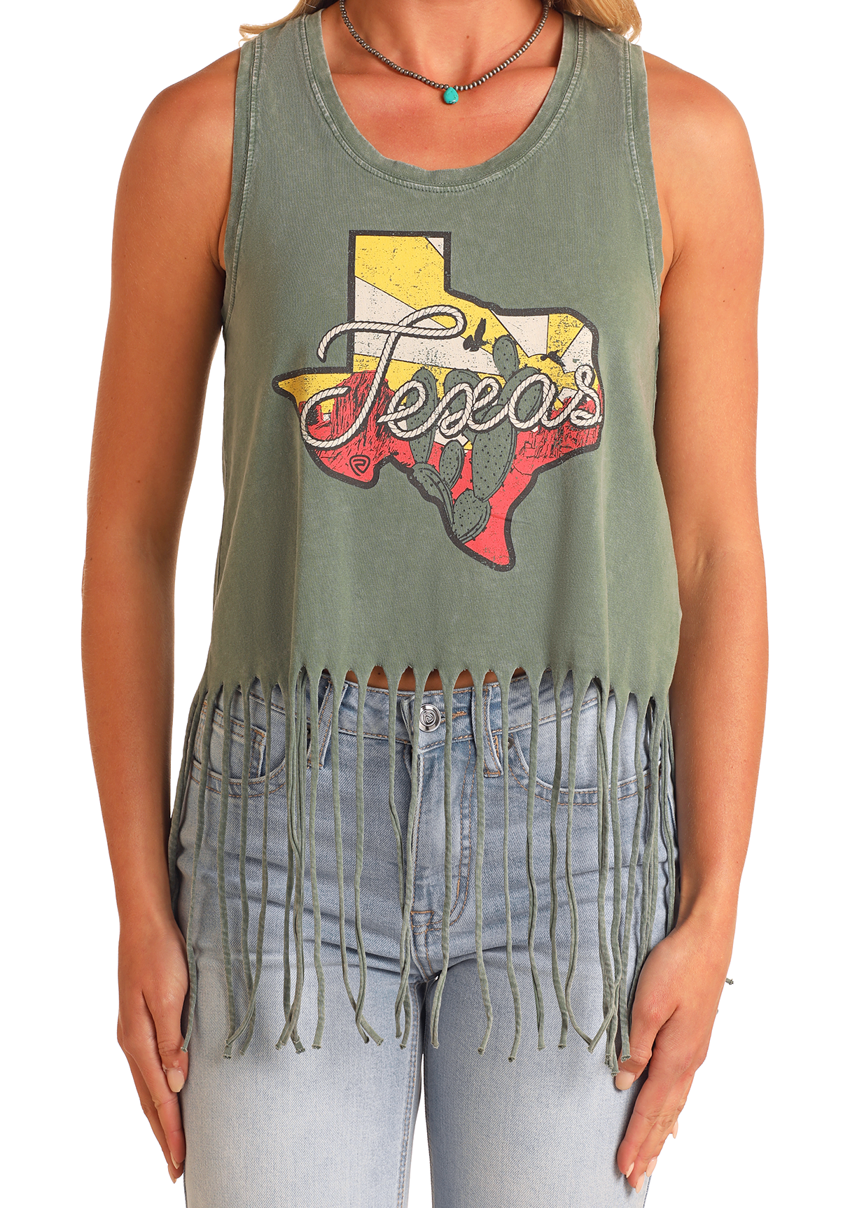 A woman wears the Rock & Roll Denim Texas Fringe Tank, a sleeveless cotton top with a "Texas" graphic, distressed look, and long fringe hem, paired casually with blue jeans.