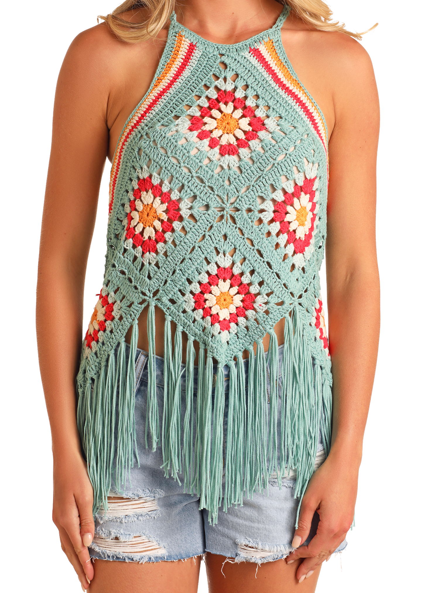 Someone wears the Rock & Roll Denim Crochet Fringe Halter Top, featuring a fringe hem and crochet patchwork with red, orange, yellow, and aqua geometric and floral patterns, paired with distressed denim shorts.