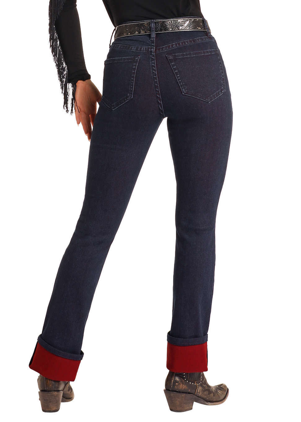 A person models Rock & Roll Denim's High Rise Two-Tone Bootcut Jeans, paired with a black fringed top, black belt, and brown leather heeled boots against a white background.