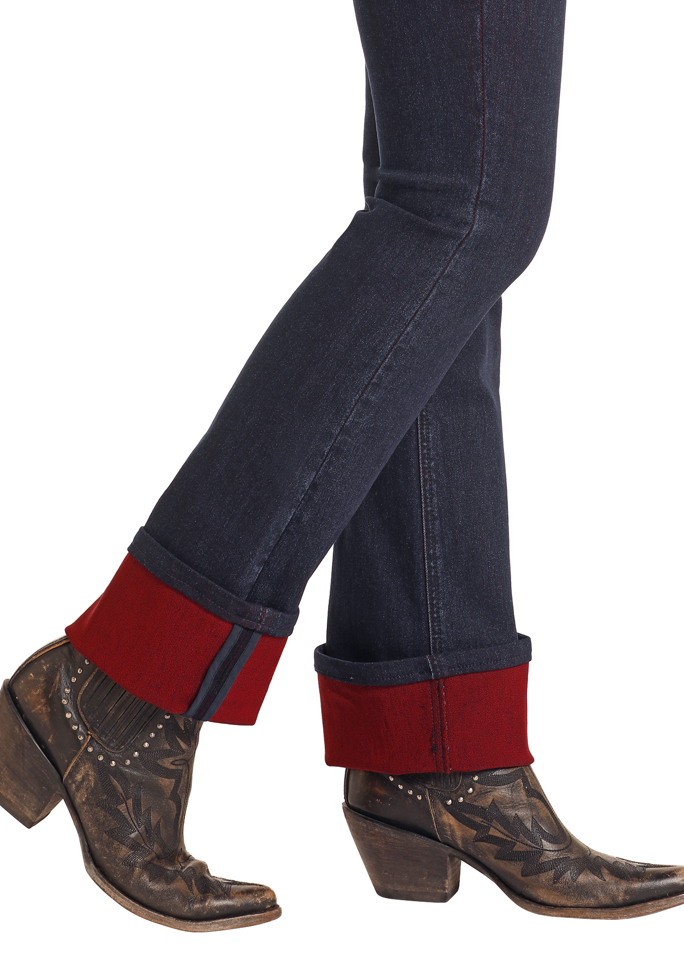 A person is walking against a white background wearing Rock & Roll Denim High Rise Two-Tone Bootcut Jeans with thick red cuffs and brown, patterned cowboy boots.