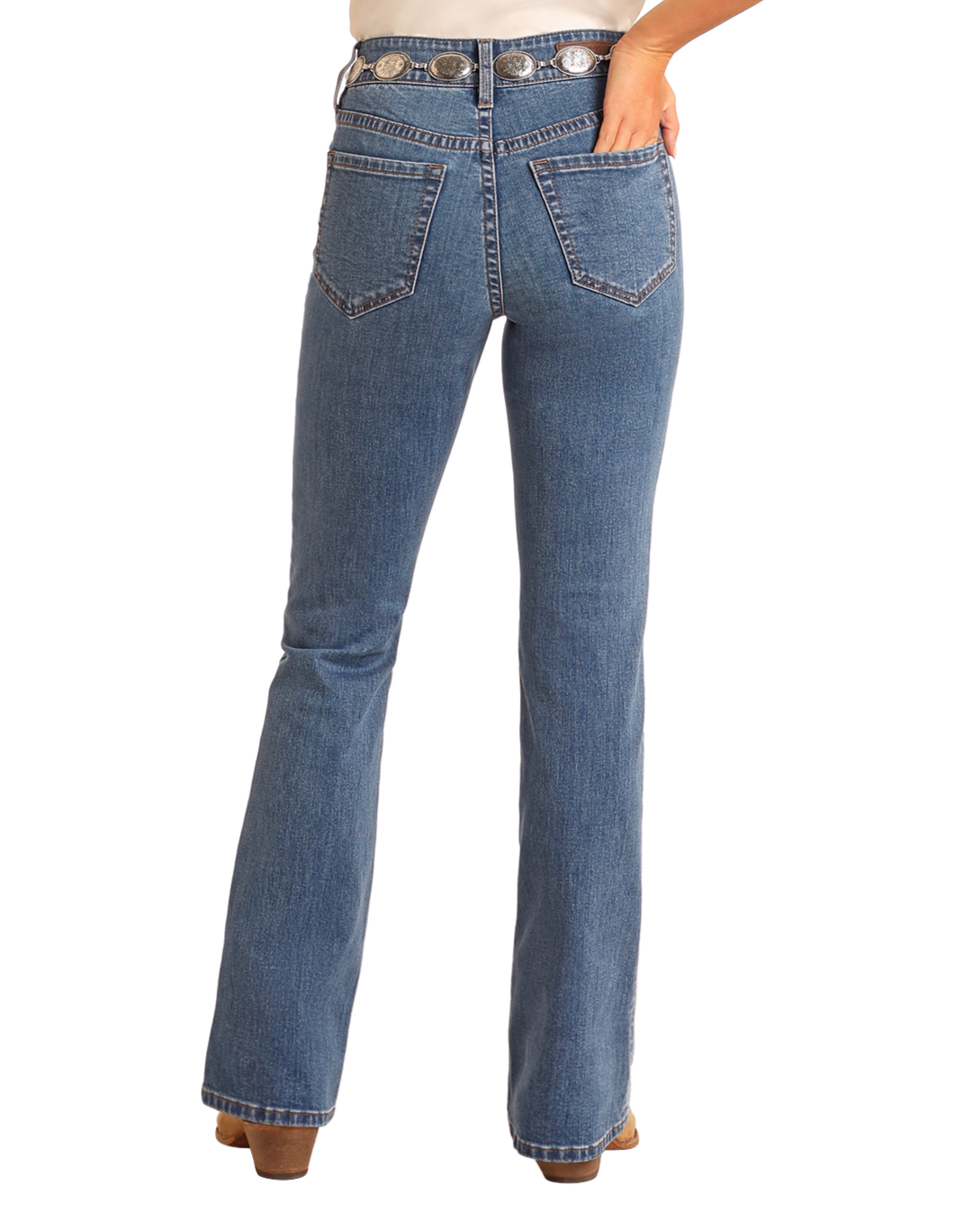 A person is seen from the back wearing Rock & Roll Denim High Rise Two-Tone Detail Bootcut Jeans with two back pockets, visible stitching, paired with brown shoes. One hand rests on their hip.