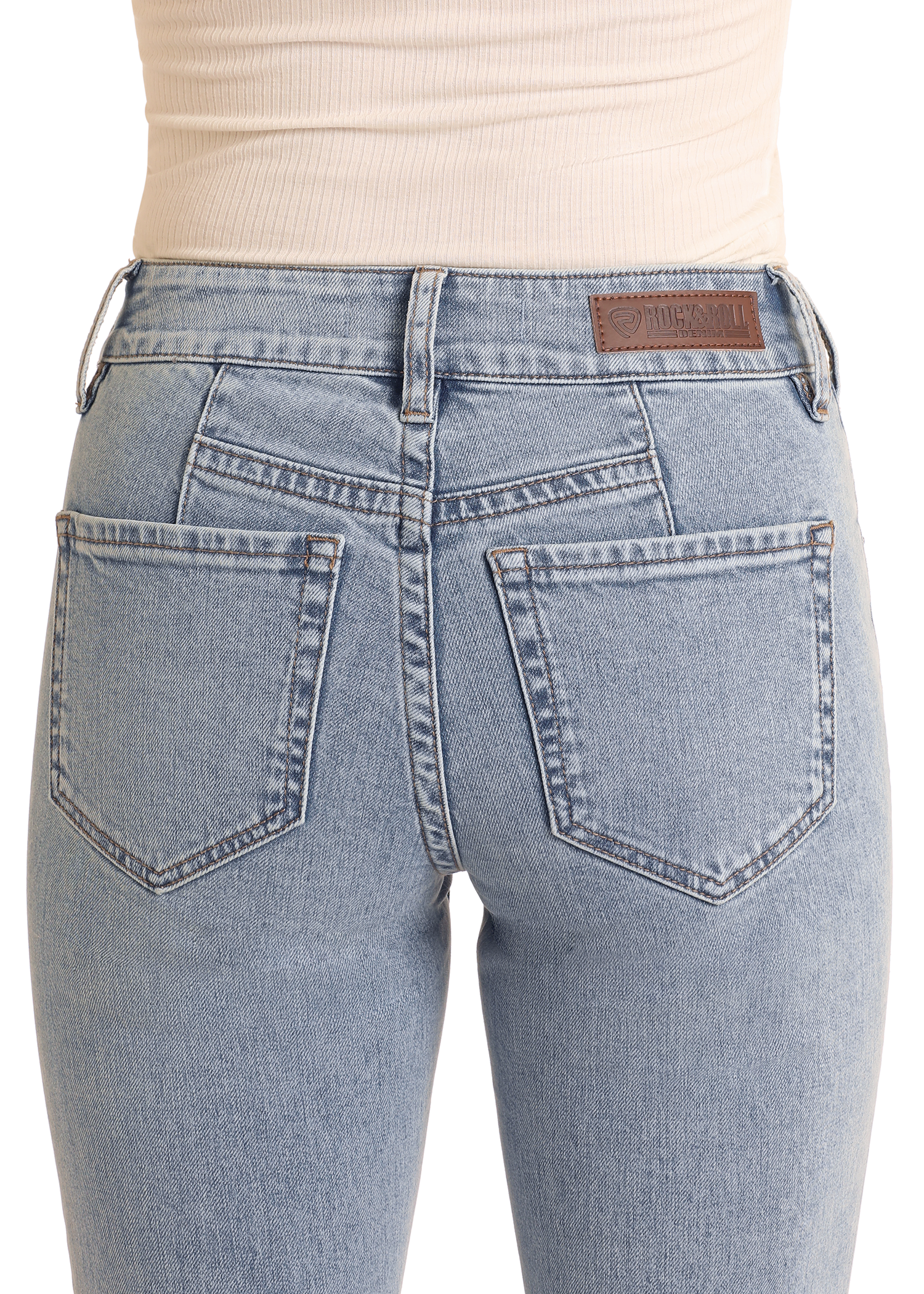 Close-up of the back of a person wearing Rock & Roll Denim High Rise Light Wash Bootcut Jeans with two back pockets and a brown leather patch, crafted from cotton spandex, paired with a beige ribbed top.