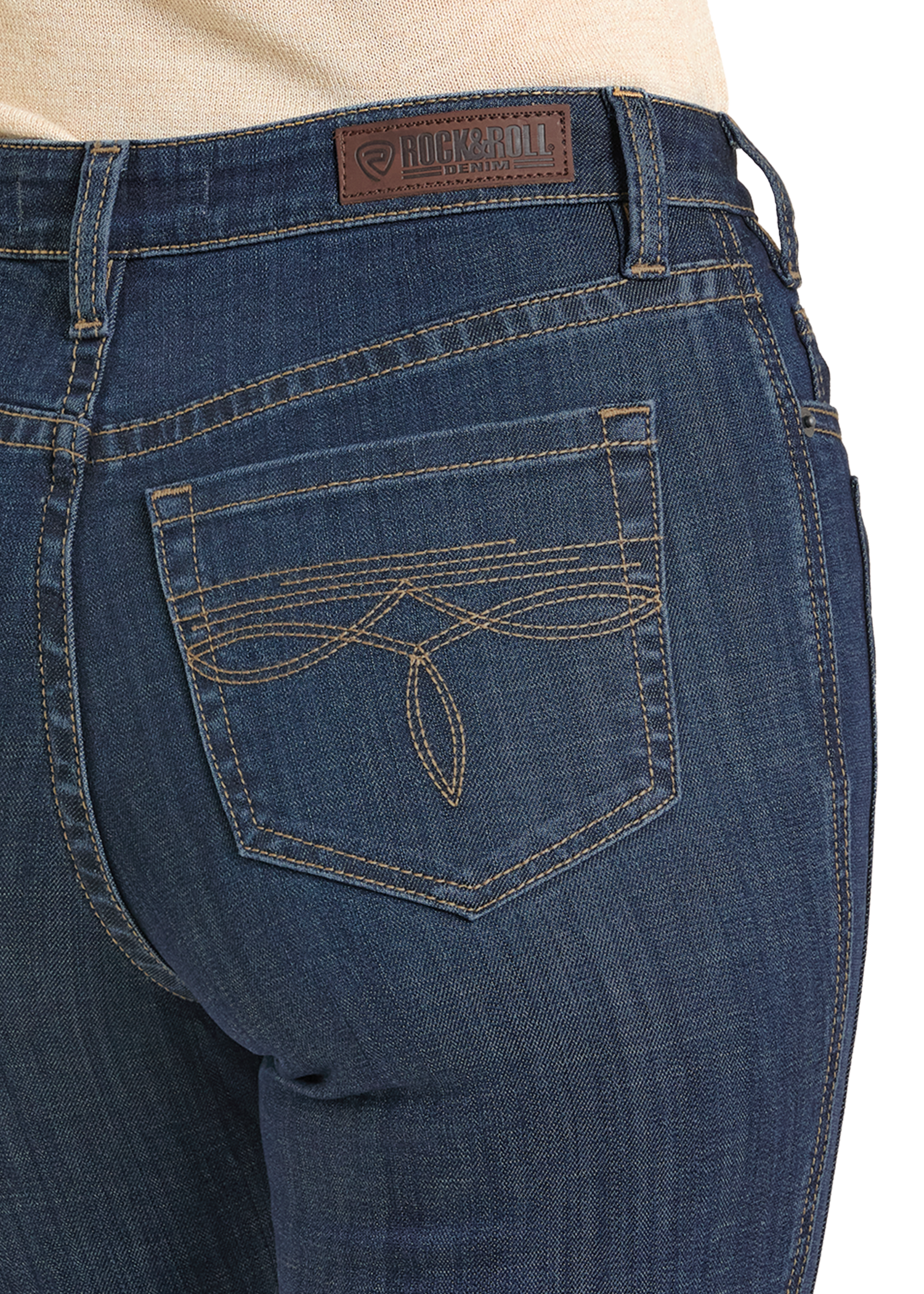 Close-up of the back pocket on High Rise Saddle Stitch Bootcut Jeans by Rock & Roll Denim, featuring decorative stitching, a logo leather patch, and a zip-fly. The cotton/spandex blend provides comfort and style.