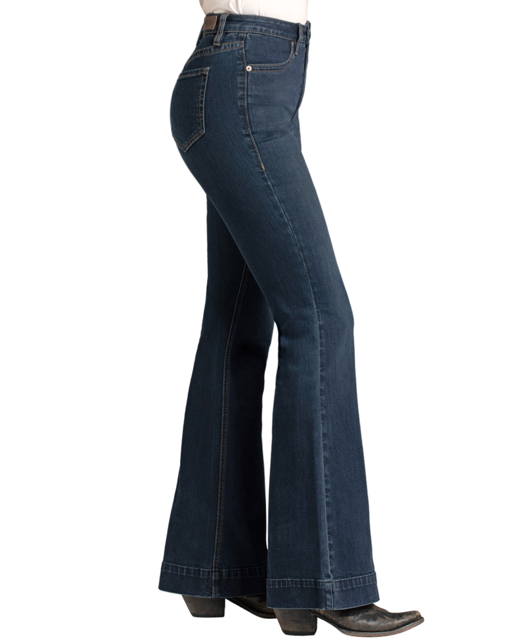 A person wears Rock & Roll Denim High Rise Stretch Dark Wash Trousers with black heeled boots, photographed from the side against a plain white background.