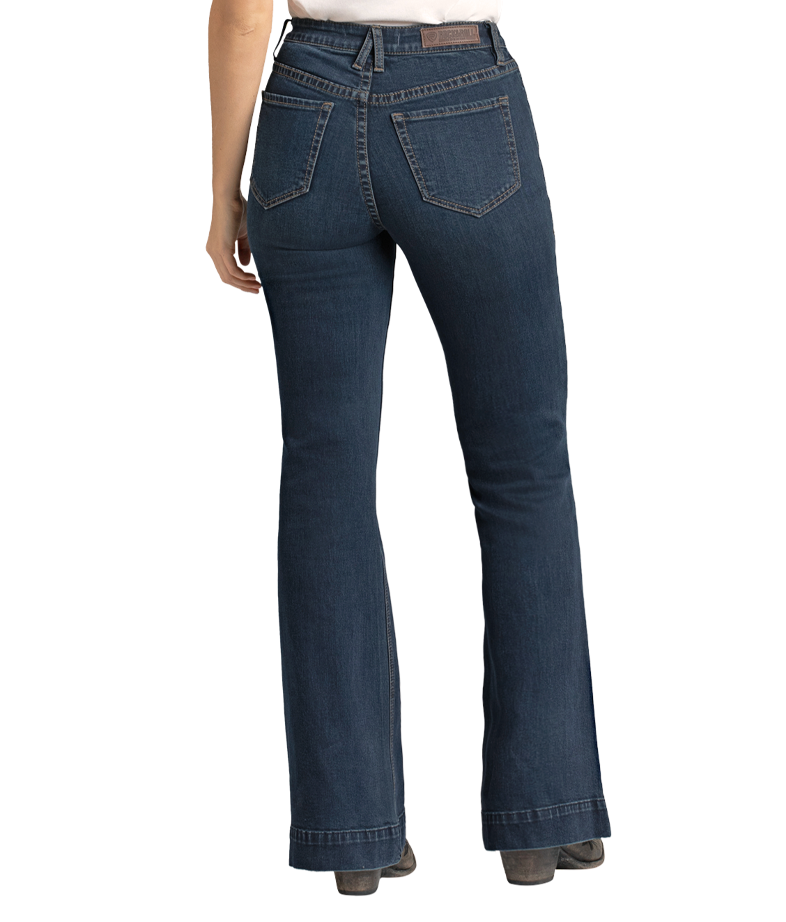 A person is seen from the back wearing Rock & Roll Denim High Rise Stretch Dark Wash Trousers and gray shoes, standing against a plain white background.
