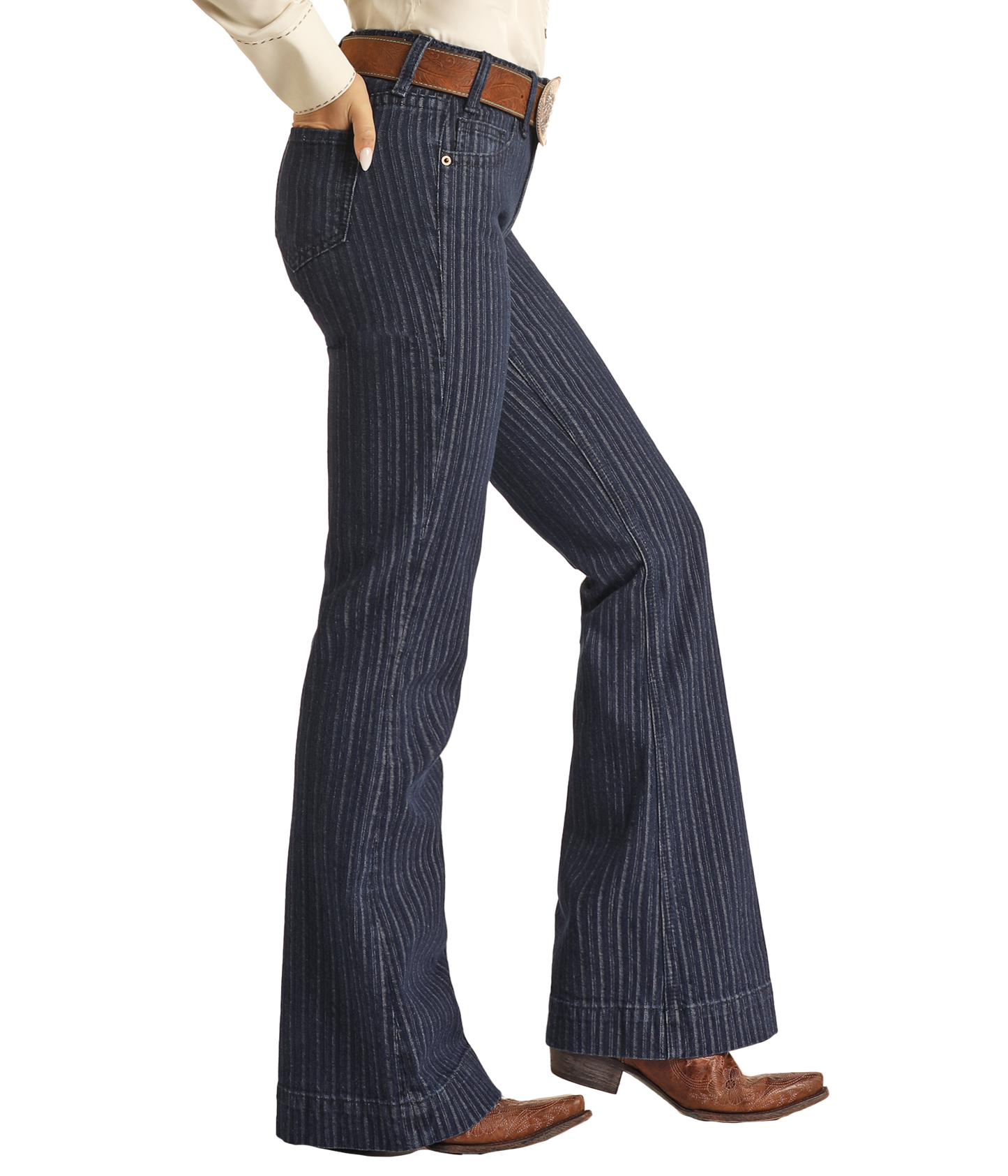 Wearing Rock & Roll Denim Jacquard Mid Rise Trouser Jeans with a brown belt, cream shirt, and cowboy boots, this person exudes western sophistication, shown from mid-torso down on a white background.