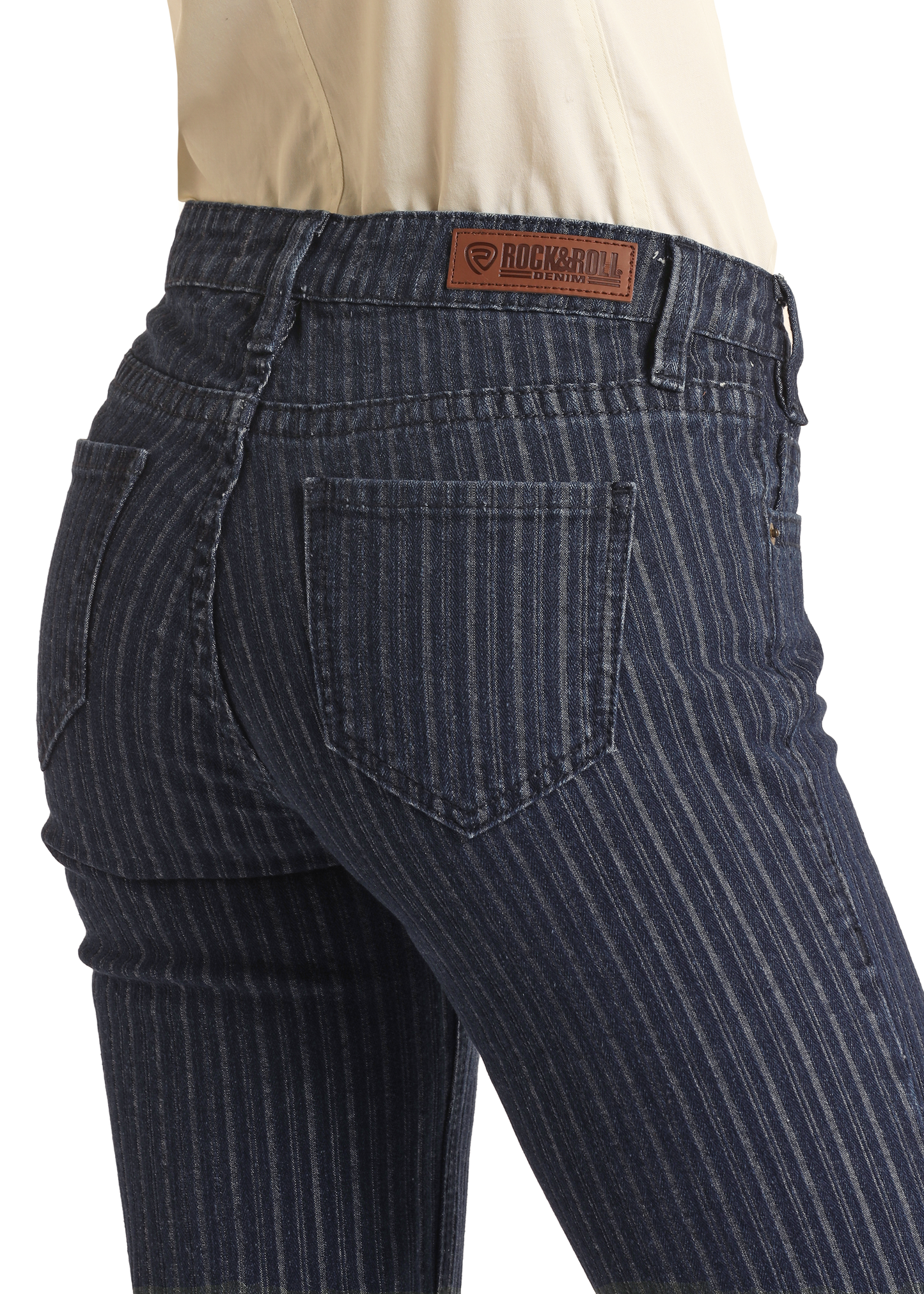 A person wears Jacquard Mid Rise Trouser Jeans by Rock & Roll Denim, featuring blue pinstripes, a visible back pocket, and a brown leather brand patch, styled with a tucked-in white top for western sophistication.