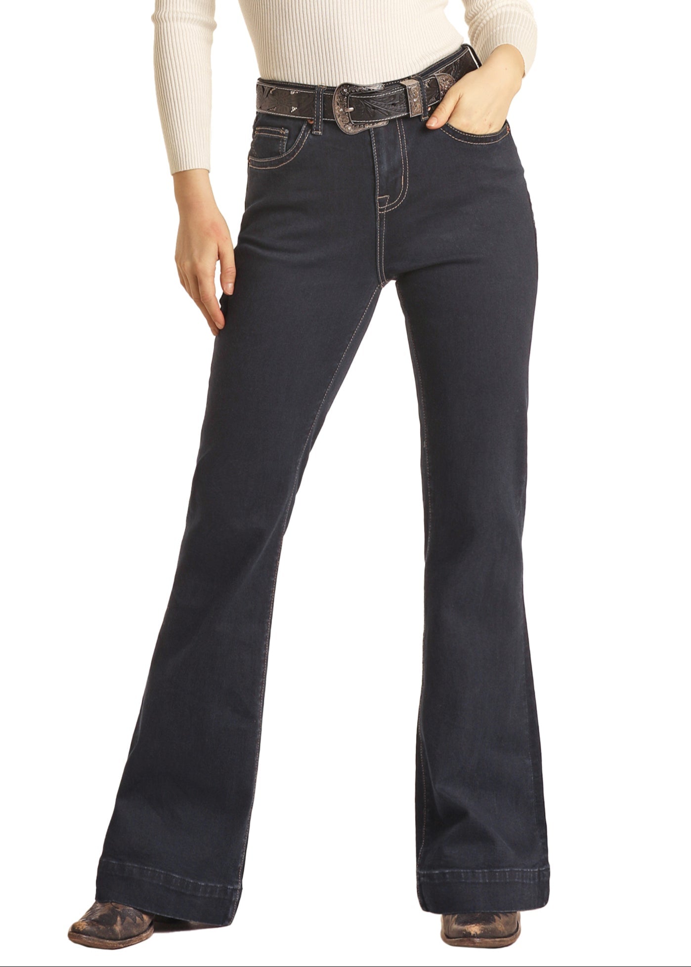 Woman wearing a cowboy hat, scarf, and dark blue jeans on a white background