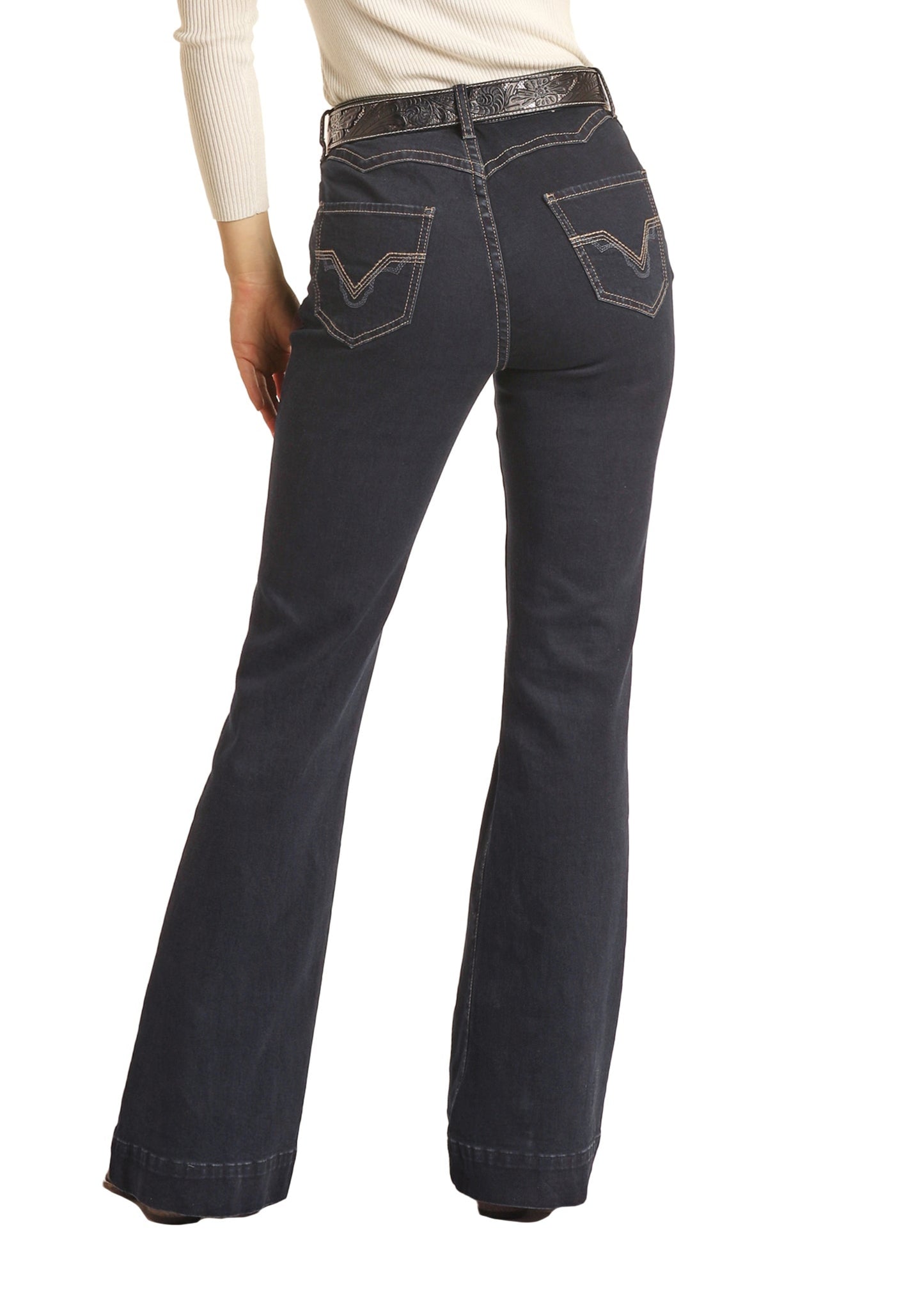 Woman wearing black jeans and a black cowboy hat on a white background