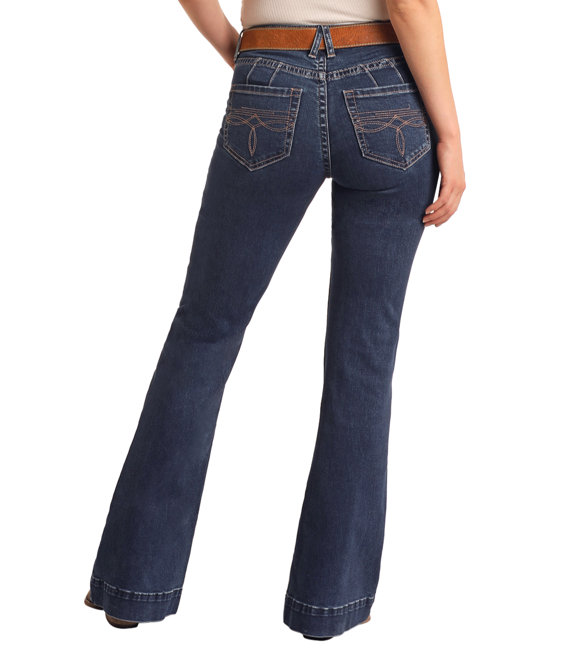 Someone stands facing away, wearing Rock & Roll Denim's Mid Rise Boot Stitch Trousers in dark blue with embroidered back pockets and a beige top.