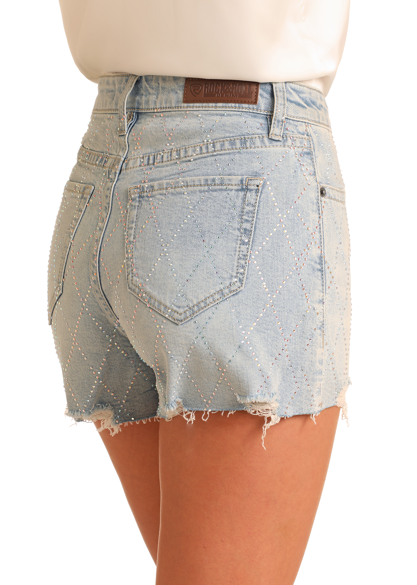 A person wears Rock & Roll Denim's Diamond Studded Shorts—trendy light blue high-rise denim shorts with diamond patterns, shiny studs, frayed hems, and back pockets.