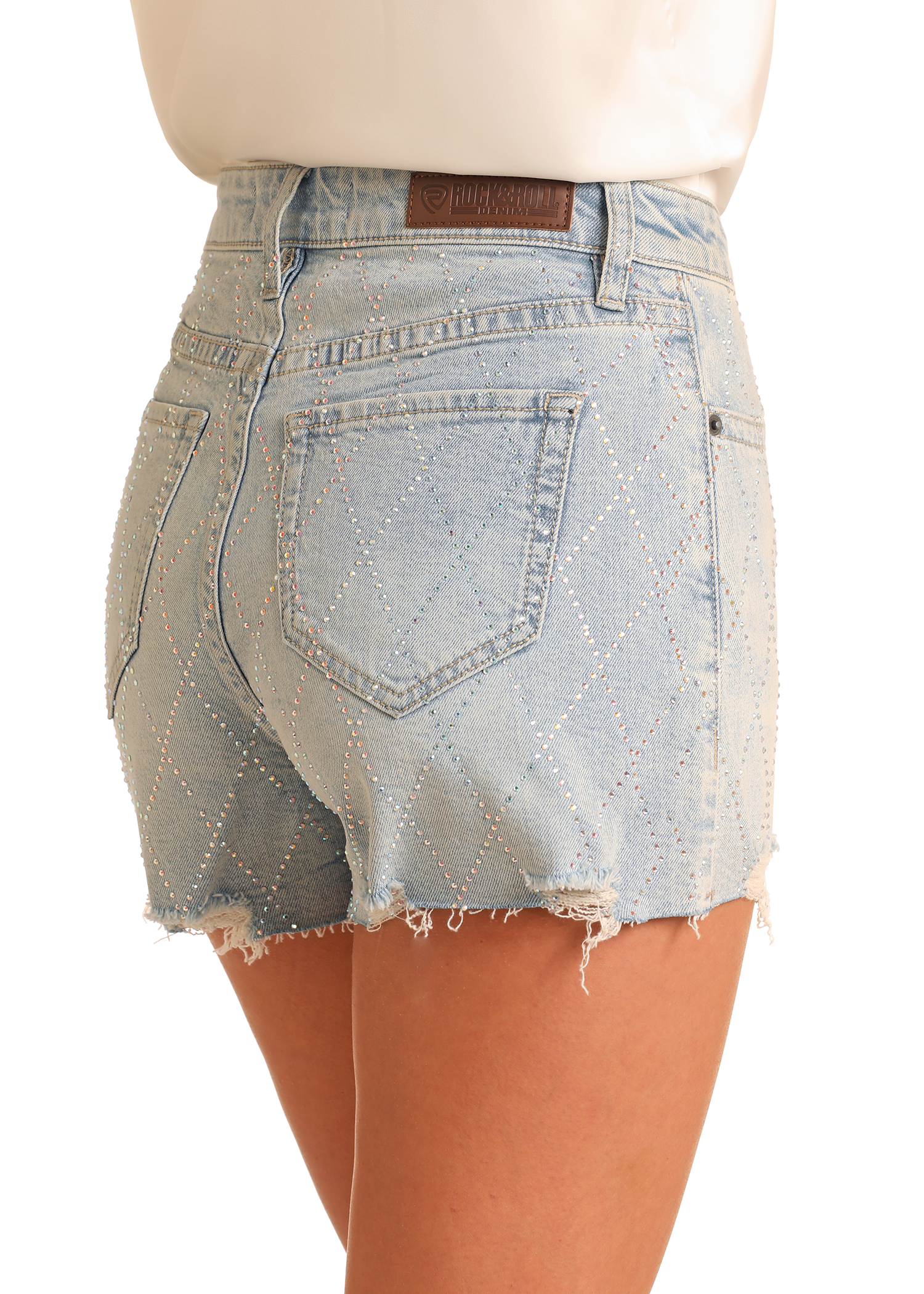 A person wears Rock & Roll Denim's Diamond Studded Shorts—trendy light blue high-rise denim shorts with diamond patterns, shiny studs, frayed hems, and back pockets.