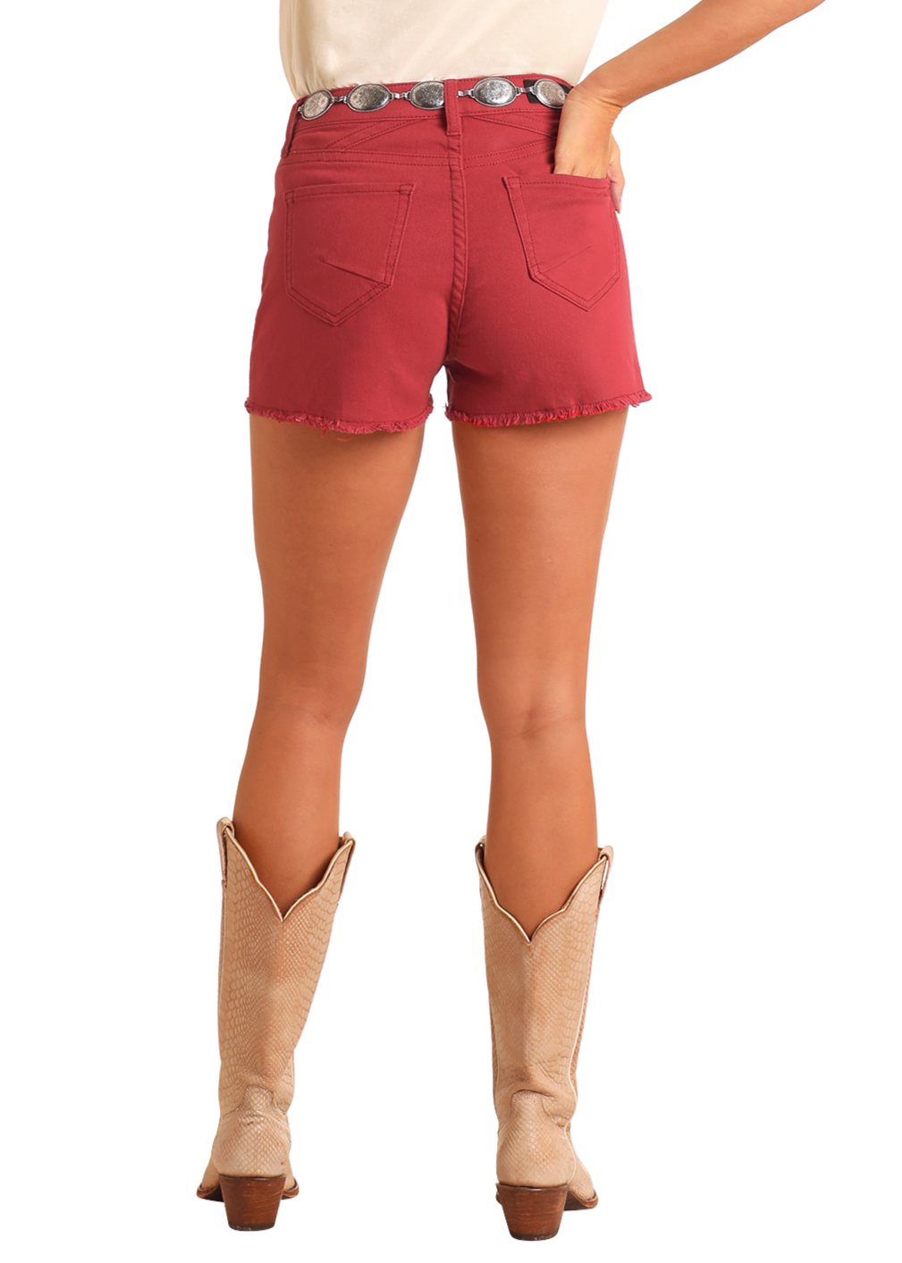 Woman wearing a white shirt, red shorts, and beige cowboy boots on a white background