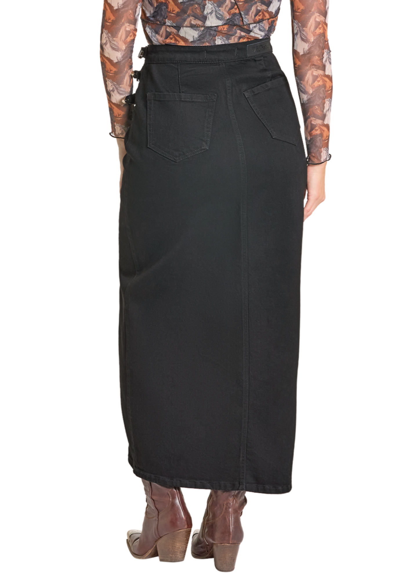 A person is shown from the back wearing the Rock & Roll Denim Buckle Denim Maxi Skirt with triple buckles, brown ankle boots, and a sheer long-sleeve top, all set against a white background.