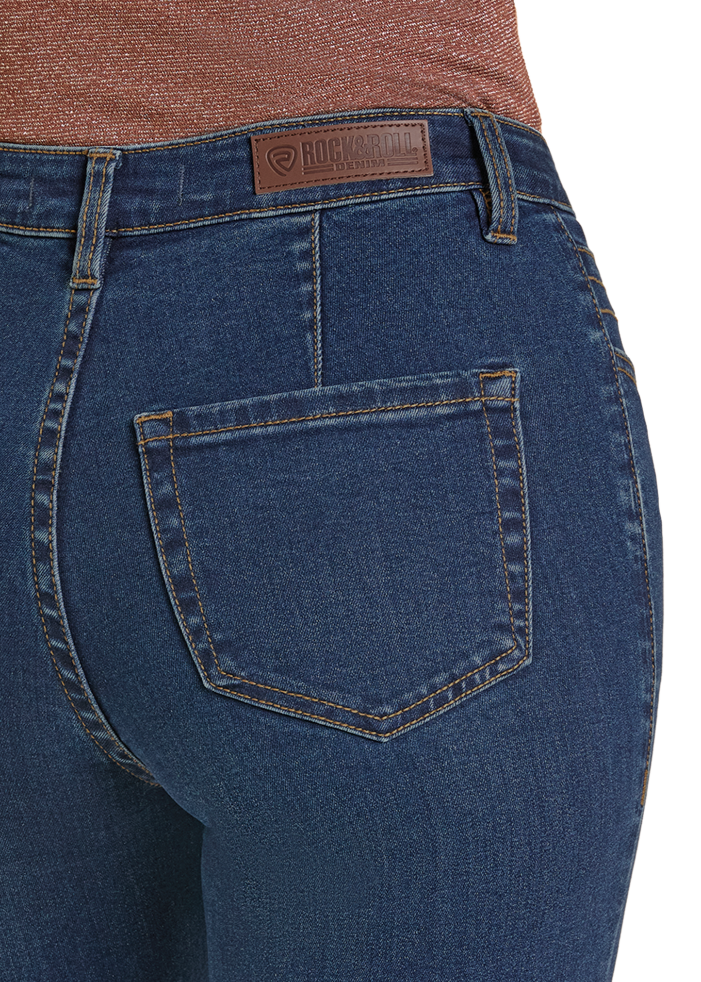 Close-up of a person wearing Rock & Roll Denim High Rise Front Pocket Flare Jeans, showcasing the back pocket and leather brand patch for a modern, stylish look.