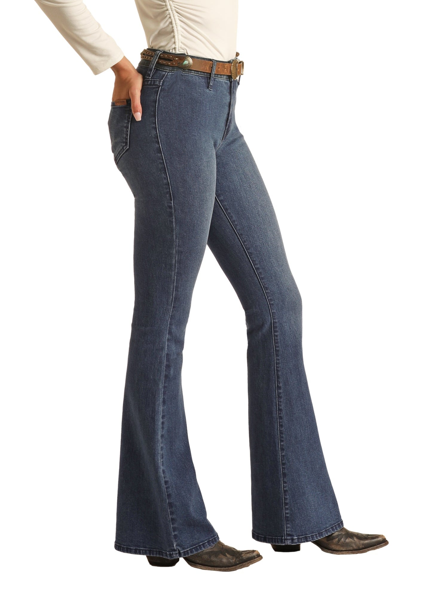 Woman wearing blue jeans and a white top with a cowboy hat on a white background