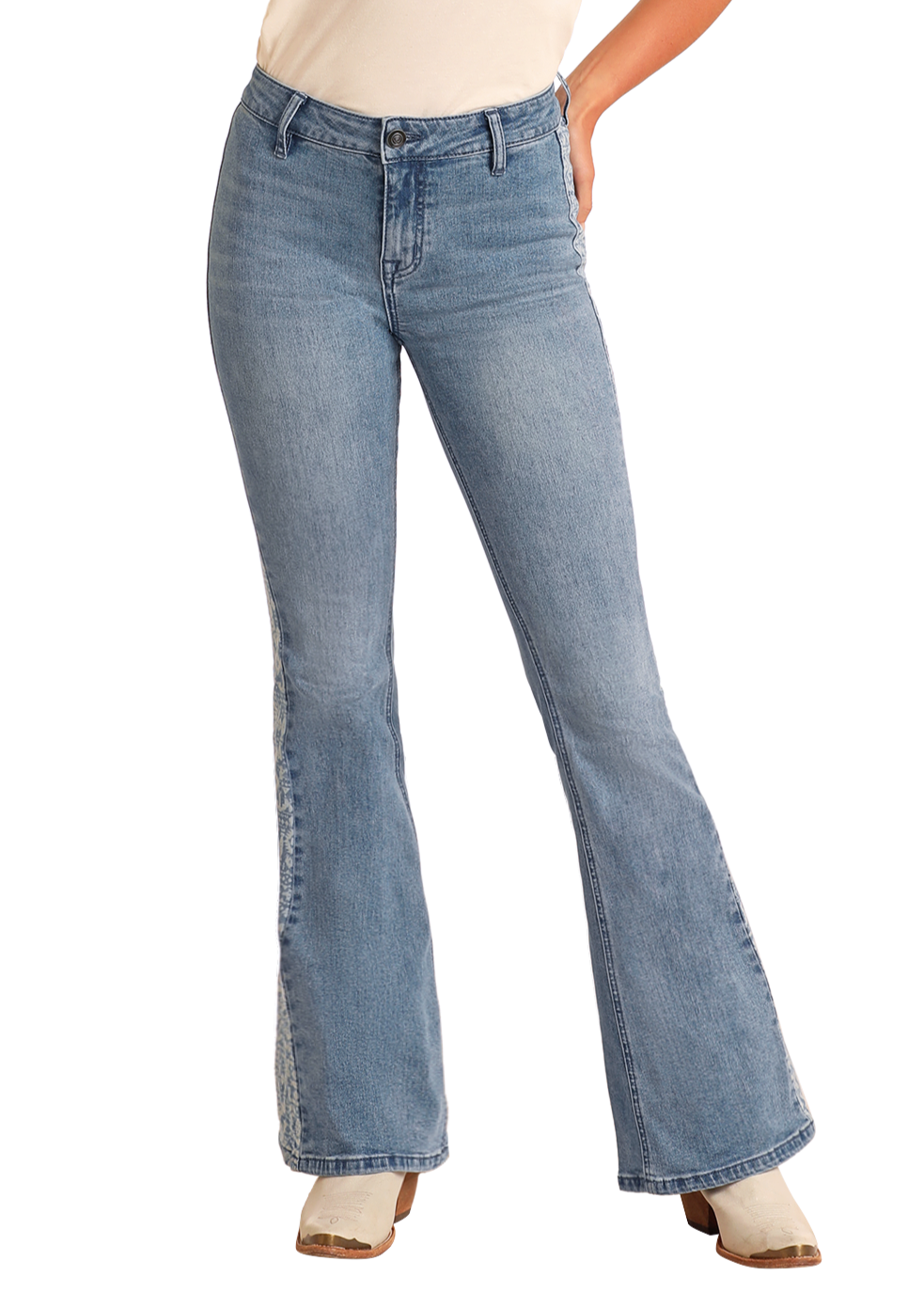 A person models Rock & Roll Denim's Aztec Panel Button Flare Jeans with a light top and white ankle boots, one hand in their pocket against a plain background—perfect for highlighting these stylish, high-waisted flare jeans.