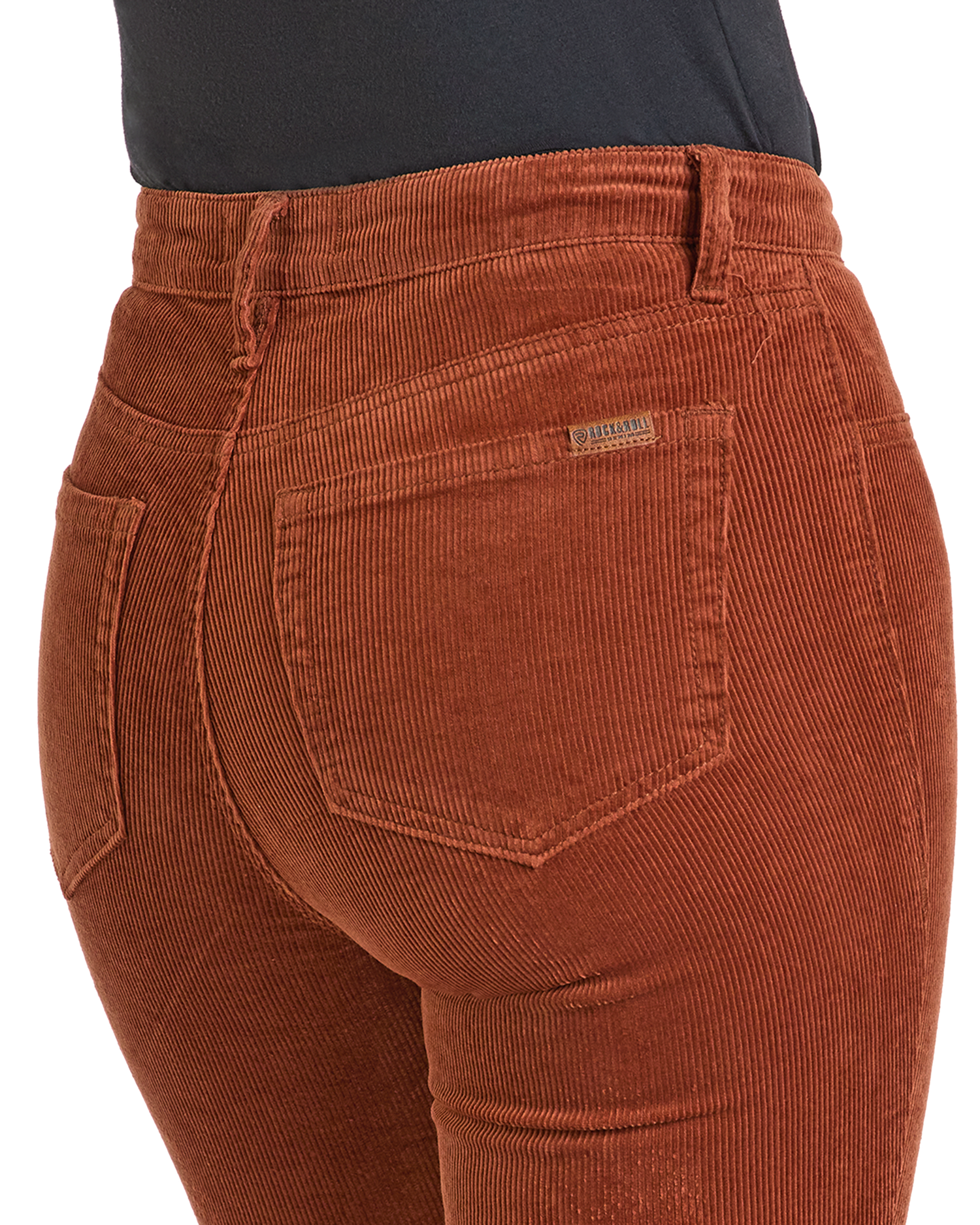 Close-up of a person wearing Rock & Roll Denim’s Rust Corduroy Flare Jeans, featuring a high-rise fit, back pocket detail, waistband, belt loops, and textured corduroy fabric.