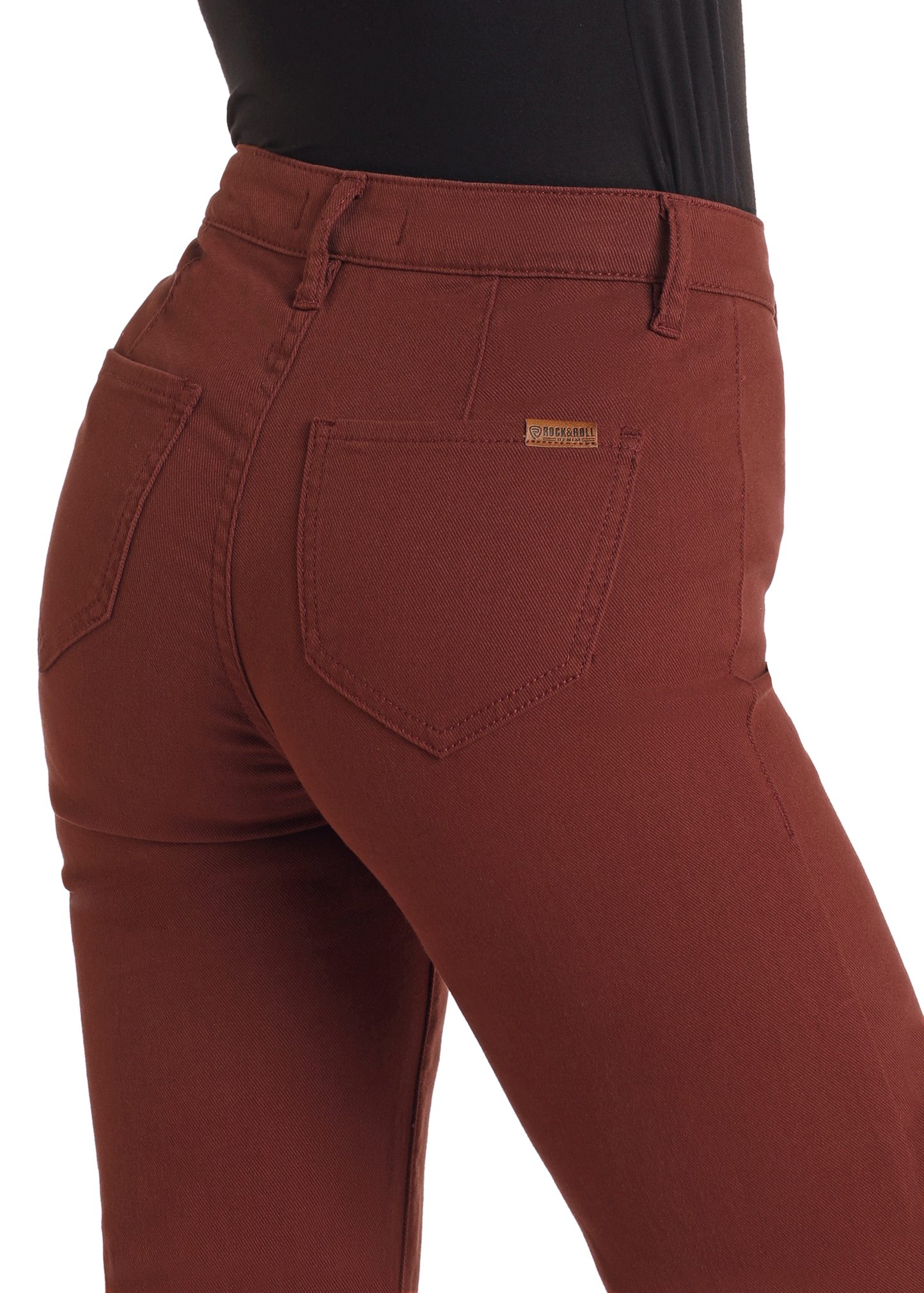 A close-up of a person wearing Rock & Roll Denim High Rise Wide Leg Flare Jeans in rust, featuring rear pockets and a small gold label on the right, paired with a fitted black top.