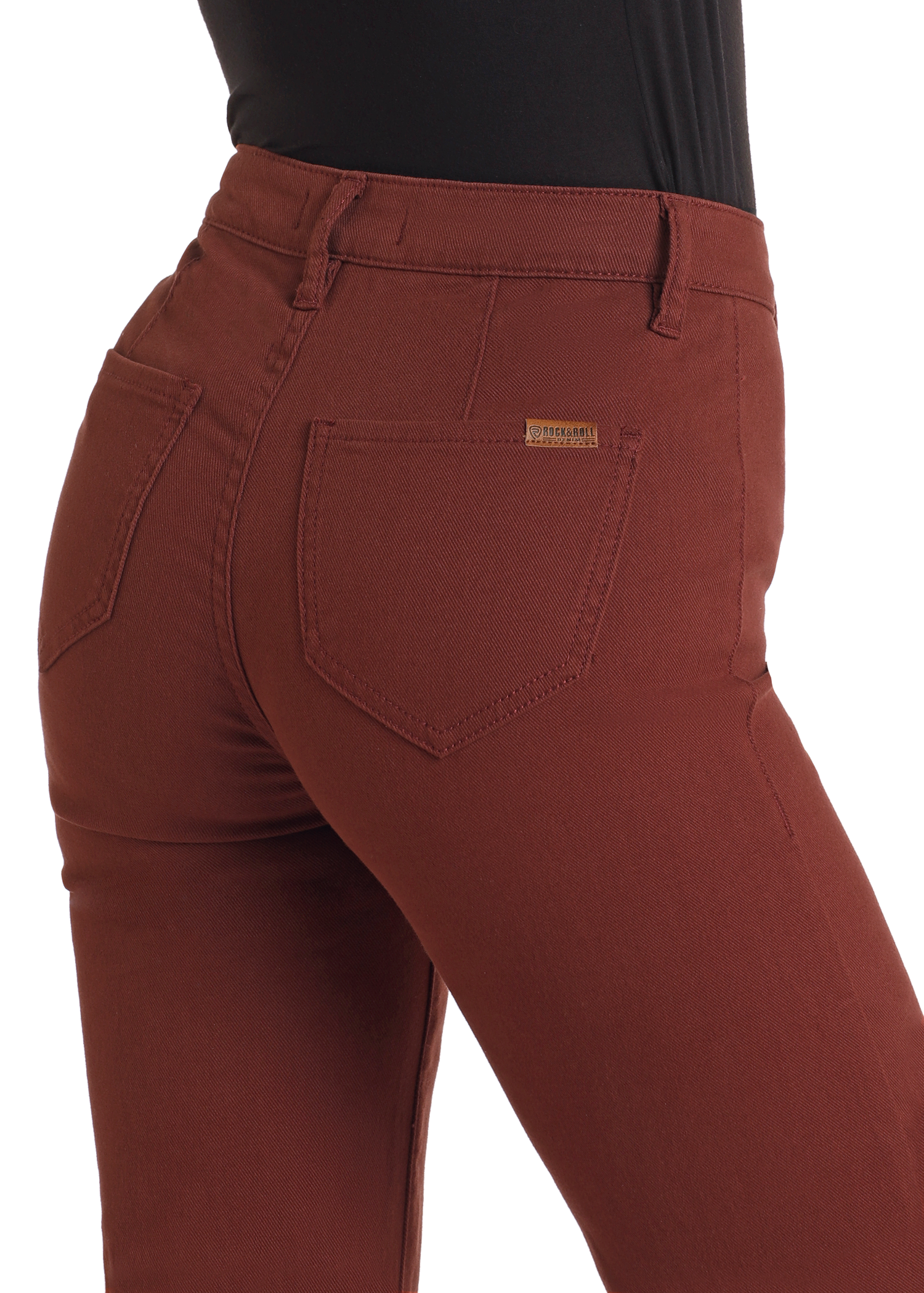 A close-up of a person wearing Rock & Roll Denim High Rise Wide Leg Flare Jeans in rust, featuring rear pockets and a small gold label on the right, paired with a fitted black top.