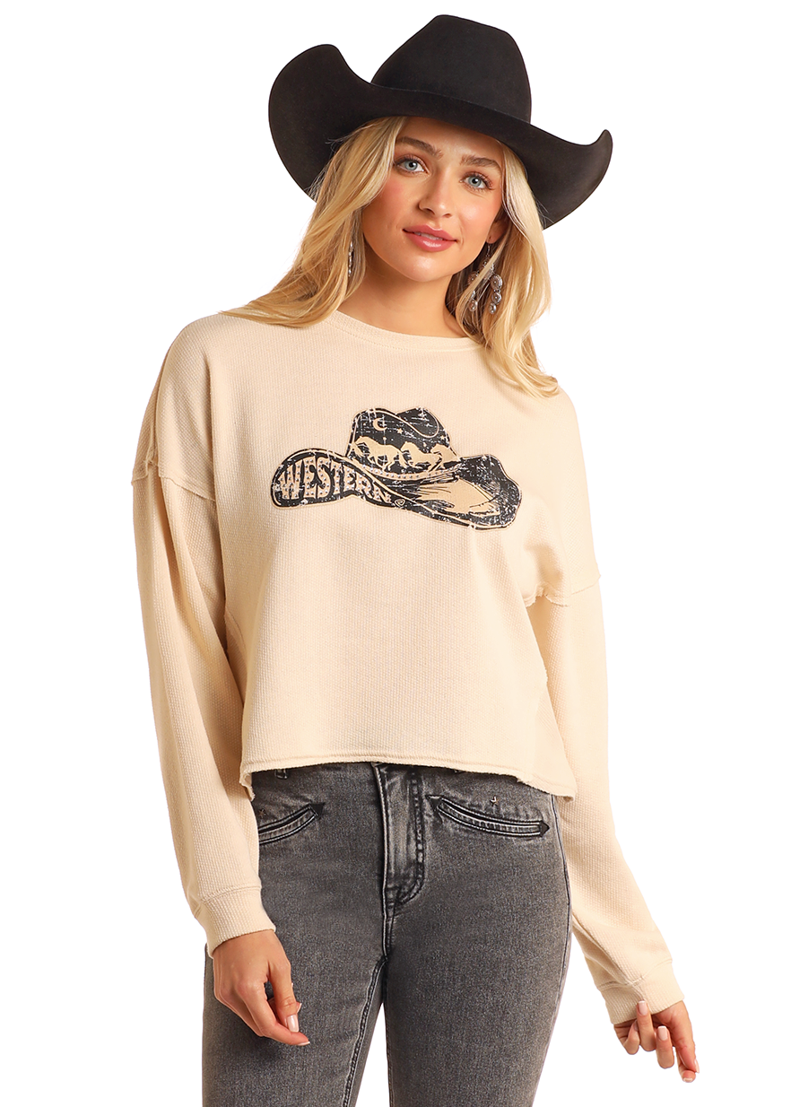 A woman in a black cowboy hat and high-waisted gray jeans models the Rock & Roll Denim Western Cropped Pullover, featuring a horse graphic and “Western” text, against a plain background.