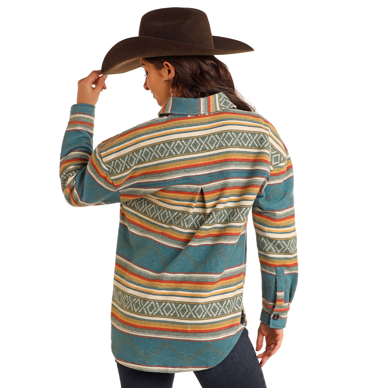 A person in a Rock & Roll Denim Turquoise Aztec Shacket and cowboy hat stands facing away, holding their hat's brim—a stylish option for casual layering.