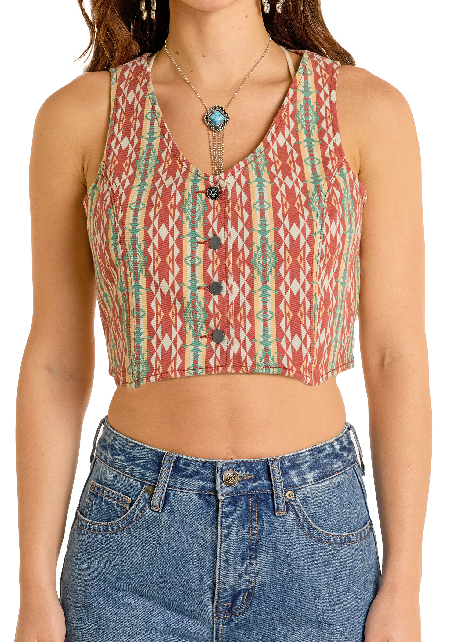 Person wearing a patterned sleeveless top and blue jeans on a white background