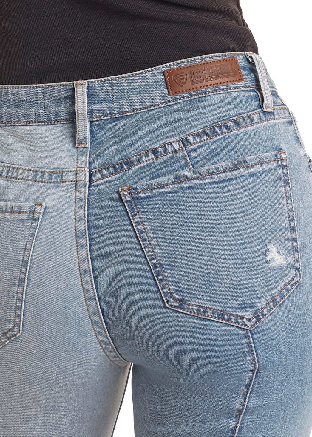 A person wearing Rock & Roll Denim High Rise Color Block Straight Cropped Jeans, featuring a leather waistband patch and a slight rip on one back pocket, shown waist down from the back.