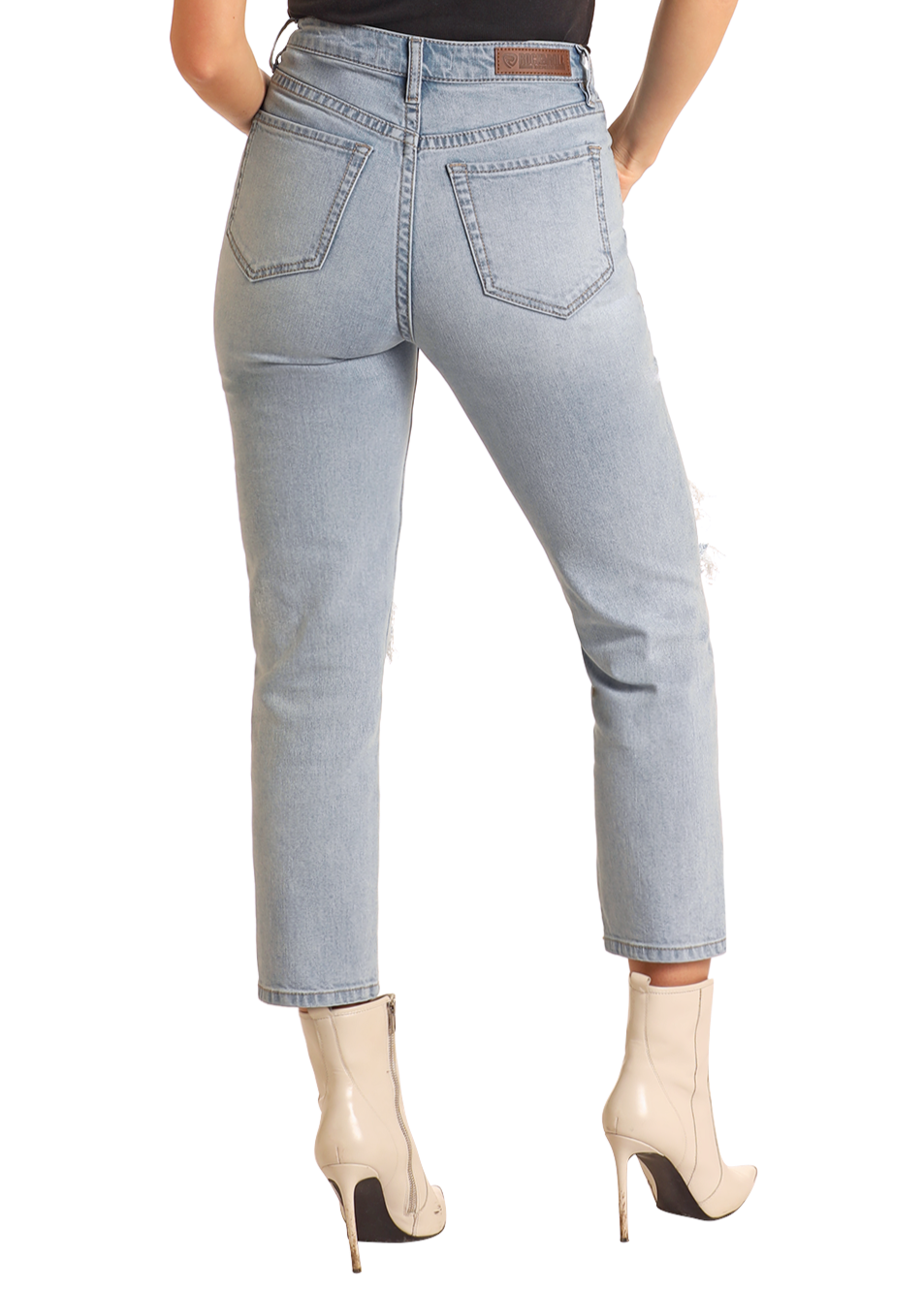 A person shown from the back wears Rock & Roll Denim’s High Rise Distressed Straight Cropped Jeans in light blue with beige heeled ankle boots, standing against a plain white background.