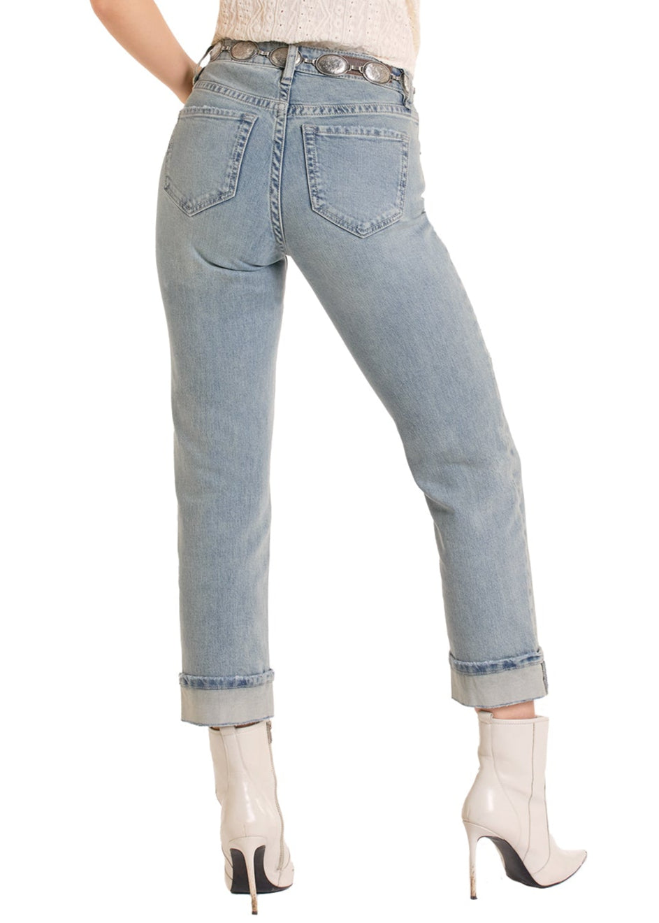 Woman wearing a white sleeveless top, light blue jeans, and a straw hat on a white background