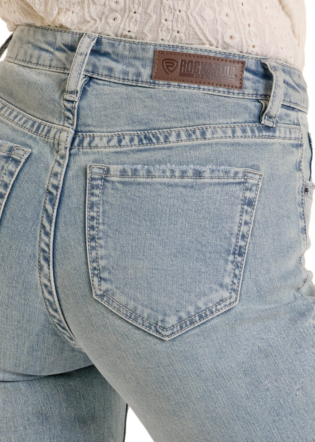 Light blue jeans with a brand logo on the back pocket against a white background