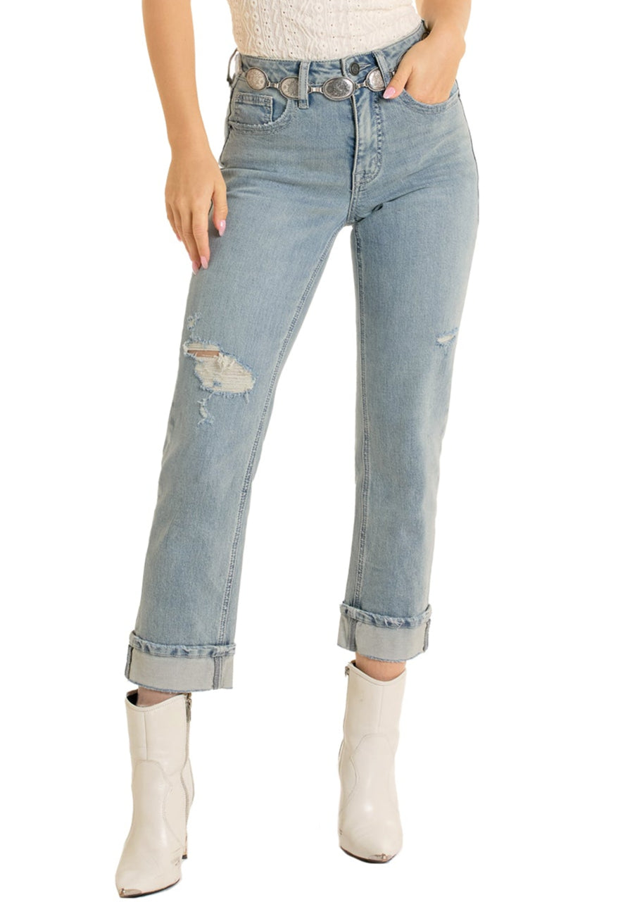 Woman wearing a white tank top, light blue jeans, and a straw cowboy hat on a white background