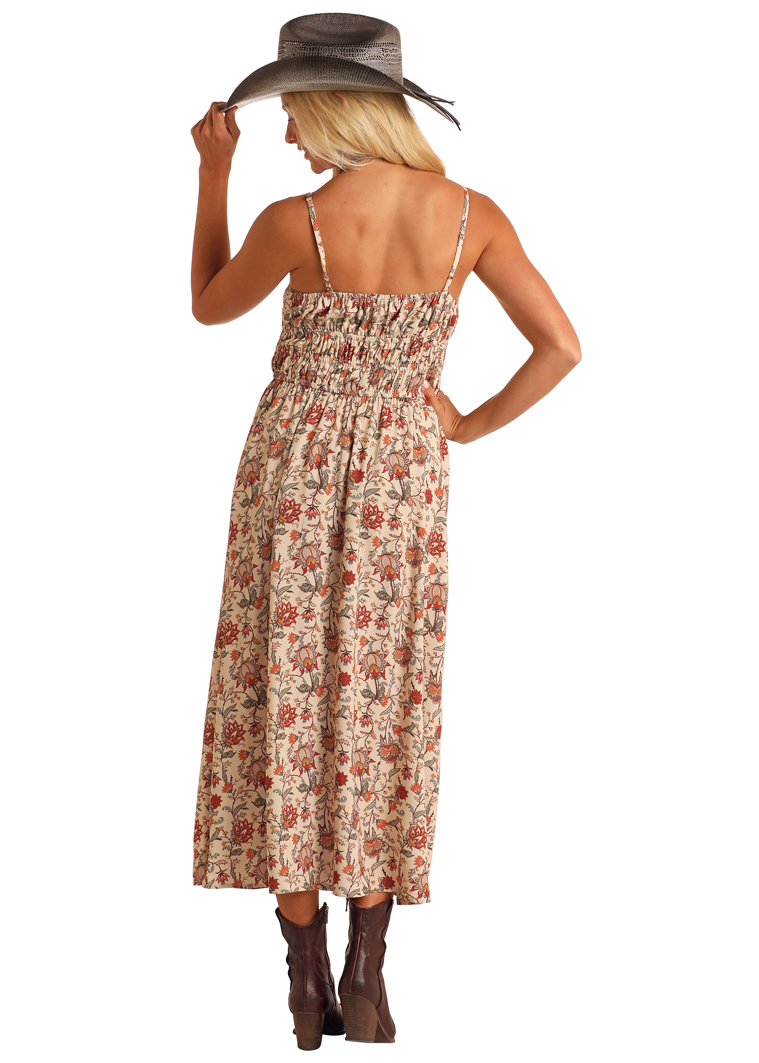 A woman with long blonde hair, wearing the Rock & Roll Denim Cream Floral Print Midi Dress, brown ankle boots, and a wide-brimmed hat, stands facing away and gently holds the brim of her hat.