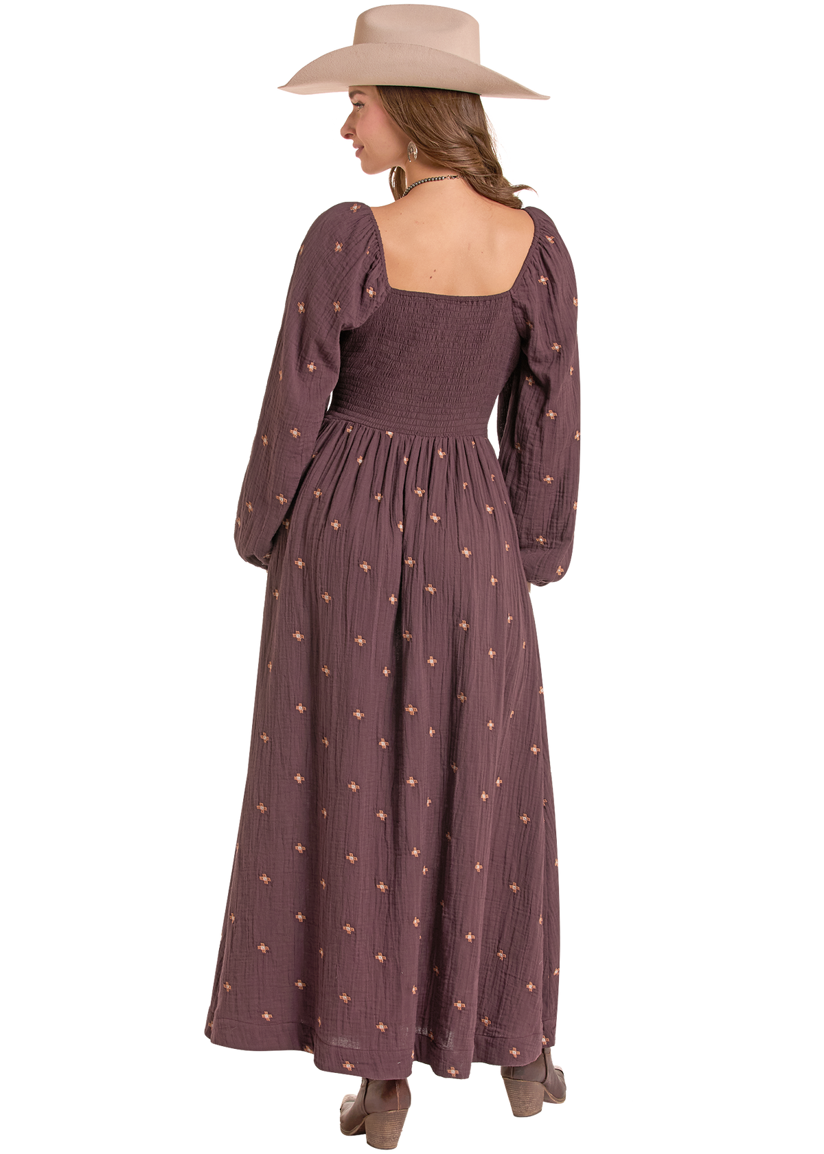 Woman wearing long sleeve brown dress.