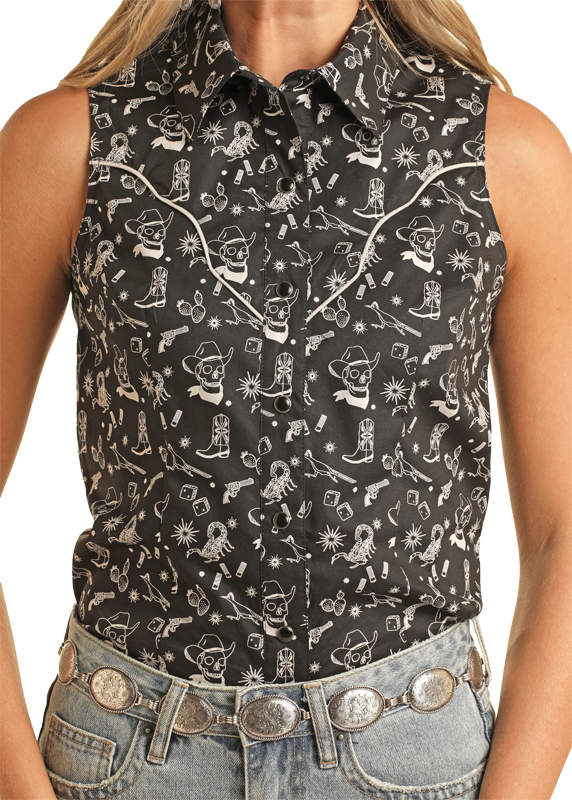 A person wears the Rock & Roll Denim Western Sleeveless Shirt - M, a black button-up with white western graphics, pointed collar, and piping, styled with light blue jeans and a silver concho belt.