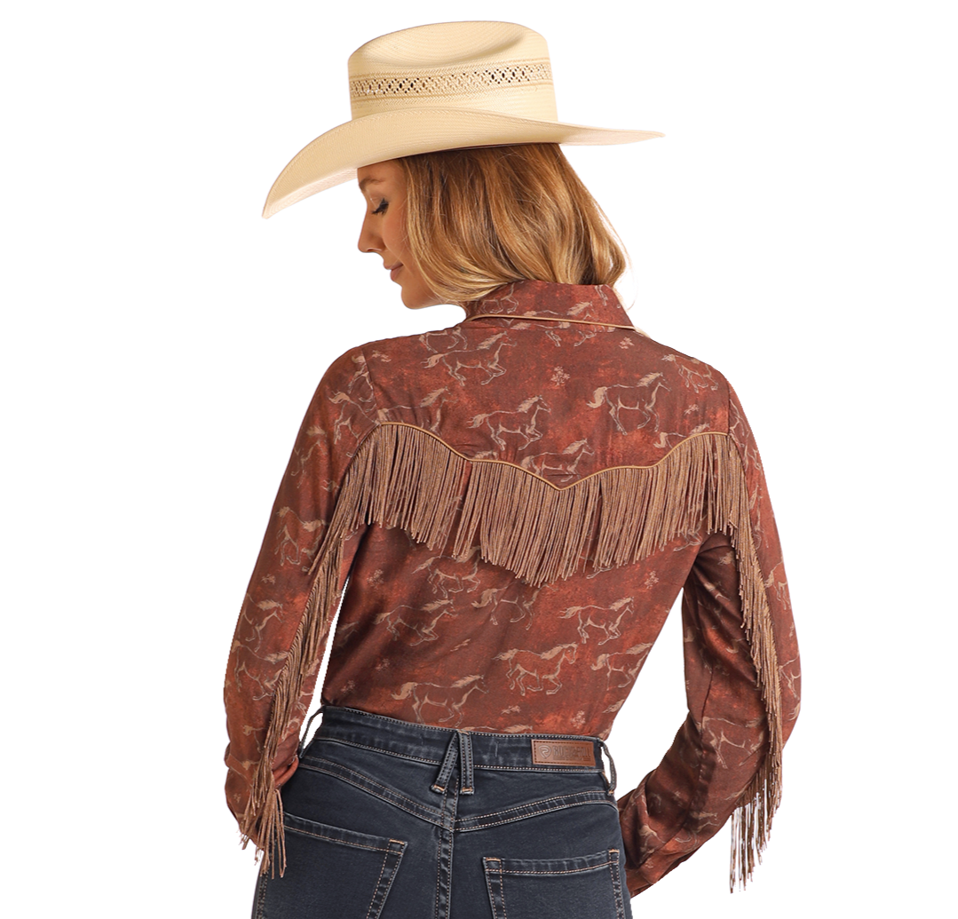 A woman, seen from behind, wears a cream cowboy hat, blue jeans, and a Rock & Roll Denim Horse Print Long Sleeve Snap Shirt.