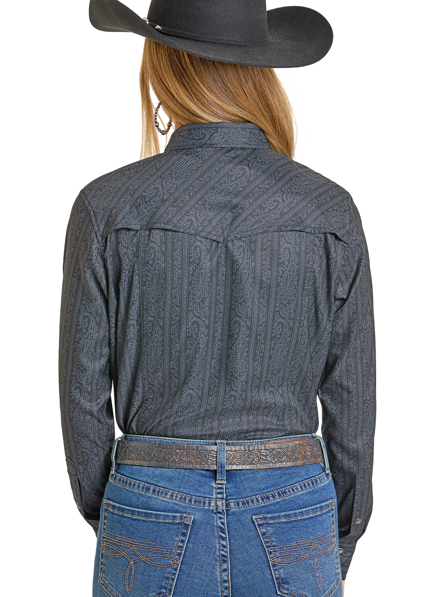 A person is shown from the back wearing a black cowboy hat, blue jeans with embroidered pockets, and a Rock & Roll Denim TEK Western Black Paisley Long Sleeve Shirt with UPF 50, featuring subtle paisley and stripe designs.