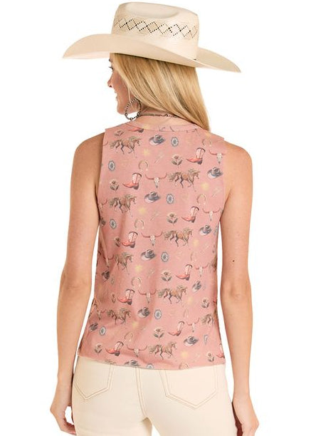 Woman wearing a pink sleeveless top with floral pattern and beige pants on a white background
