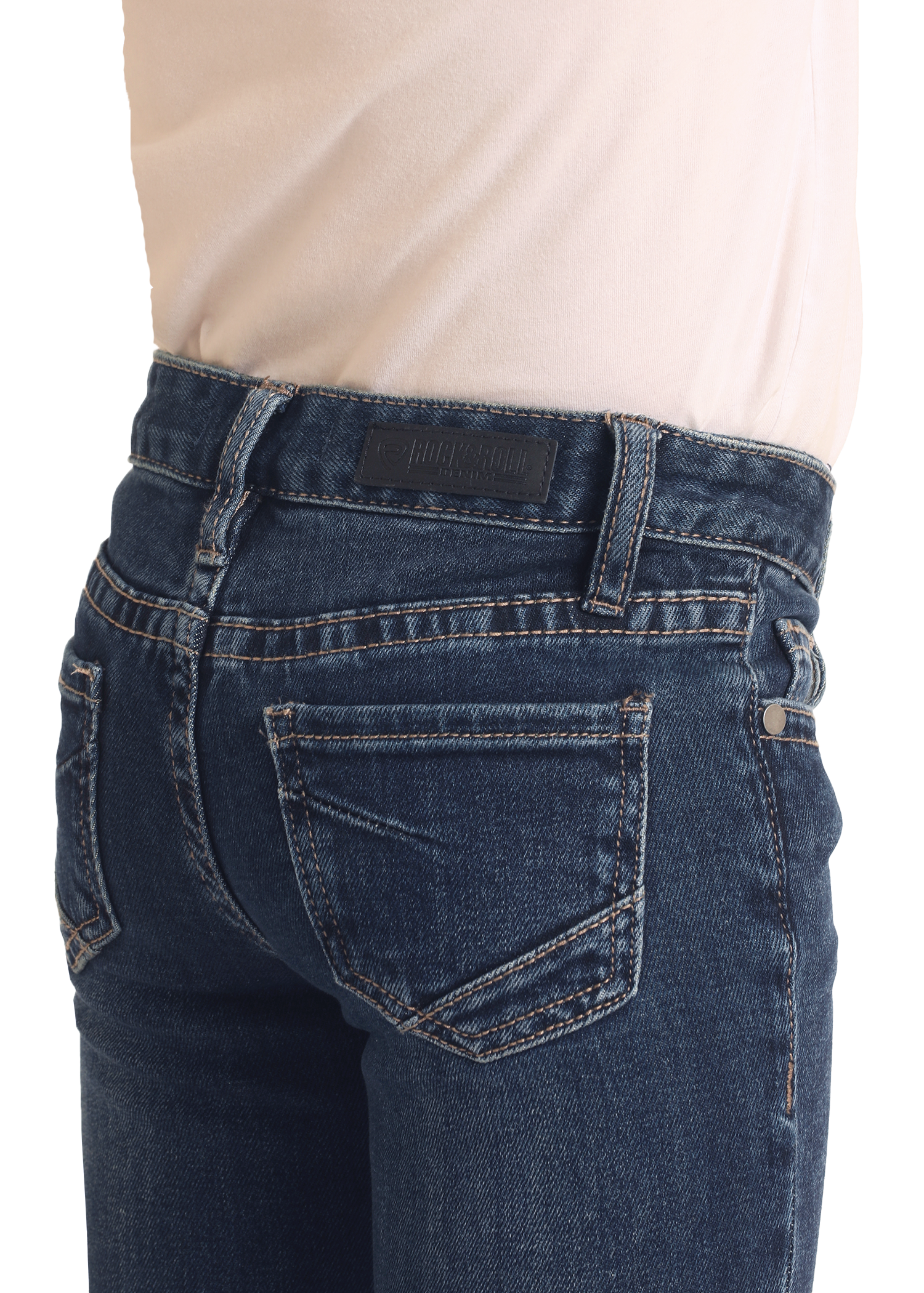 A close-up of a person wearing Rock & Roll Denim Girls' Extra Stretch Mid Rise Trouser Jeans with a light beige shirt, showcasing the stylish back pocket and waistband details of these jeans.