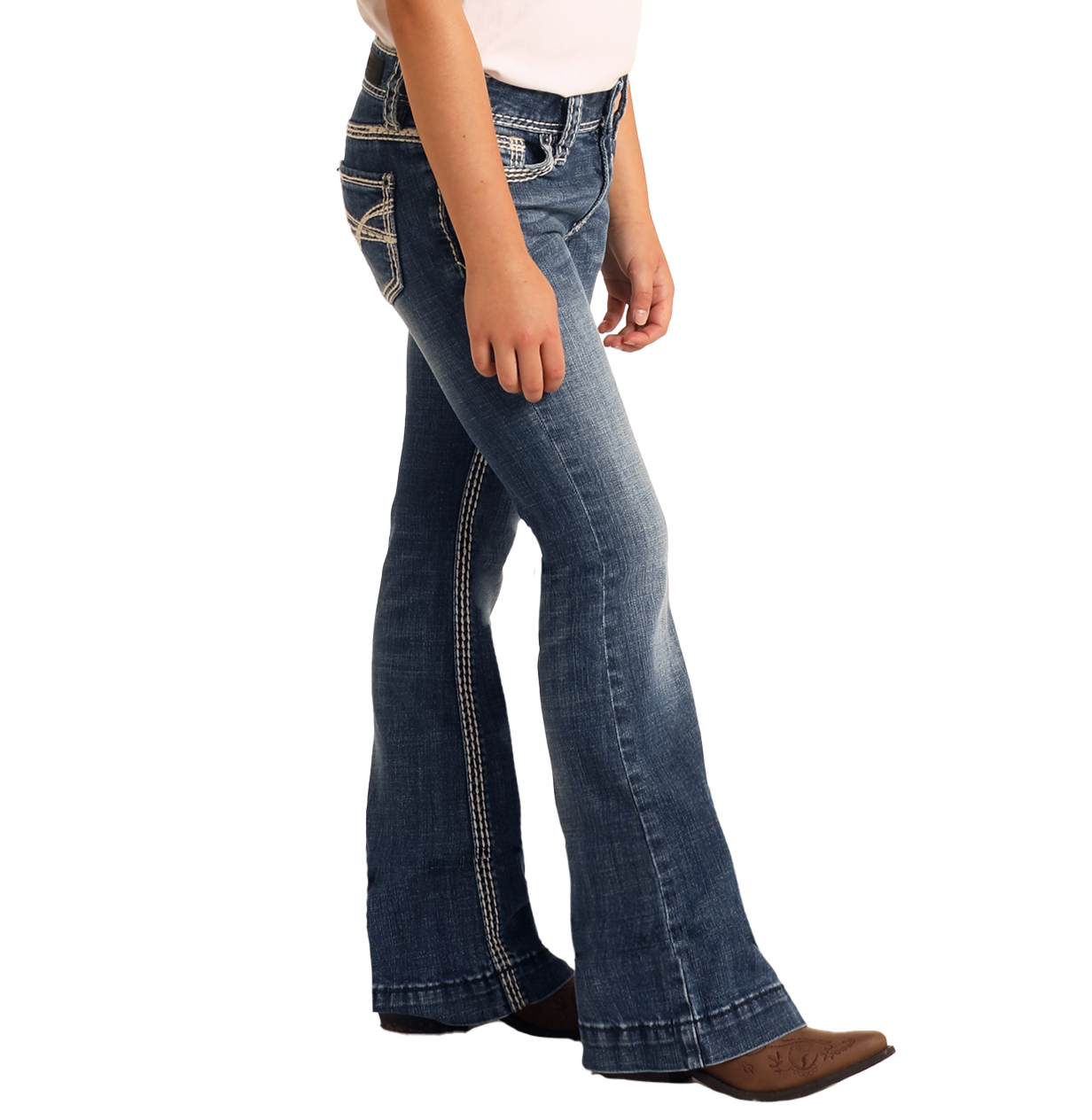A girl wearing Rock & Roll Denim Girls' Heavy Stitch Trouser Jeans and brown pointed-toe shoes stands against a plain white background.