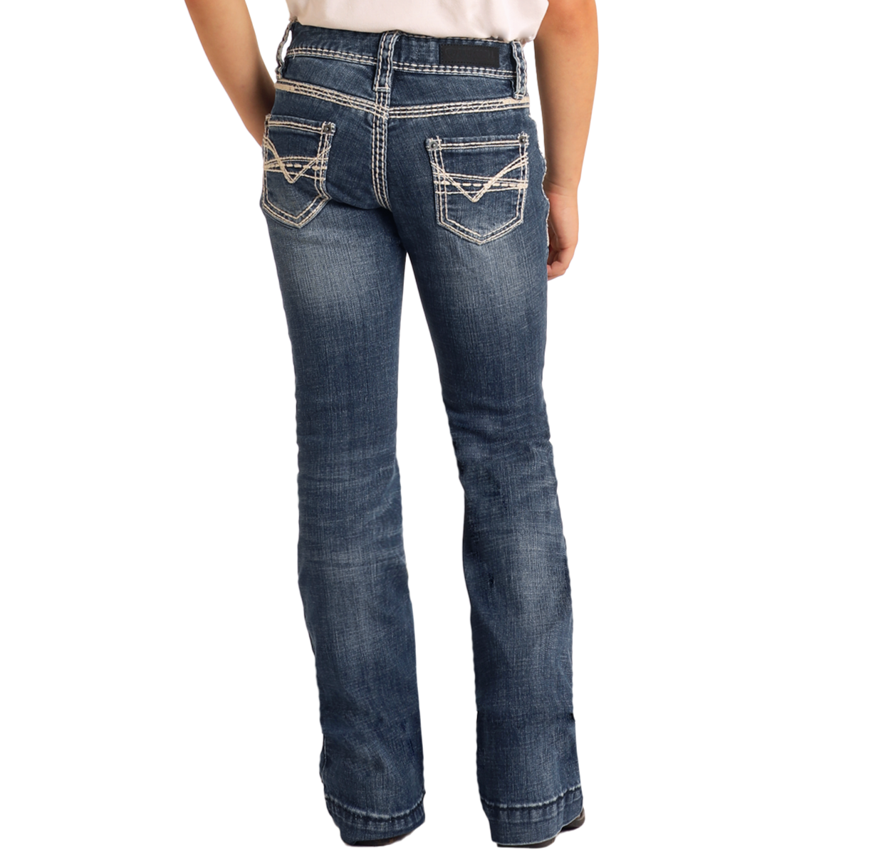 A person stands with their back to the camera against a plain light background, wearing Rock & Roll Denim Girls' Heavy Stitch Trouser Jeans featuring white contrast stitching and decorative back pockets.