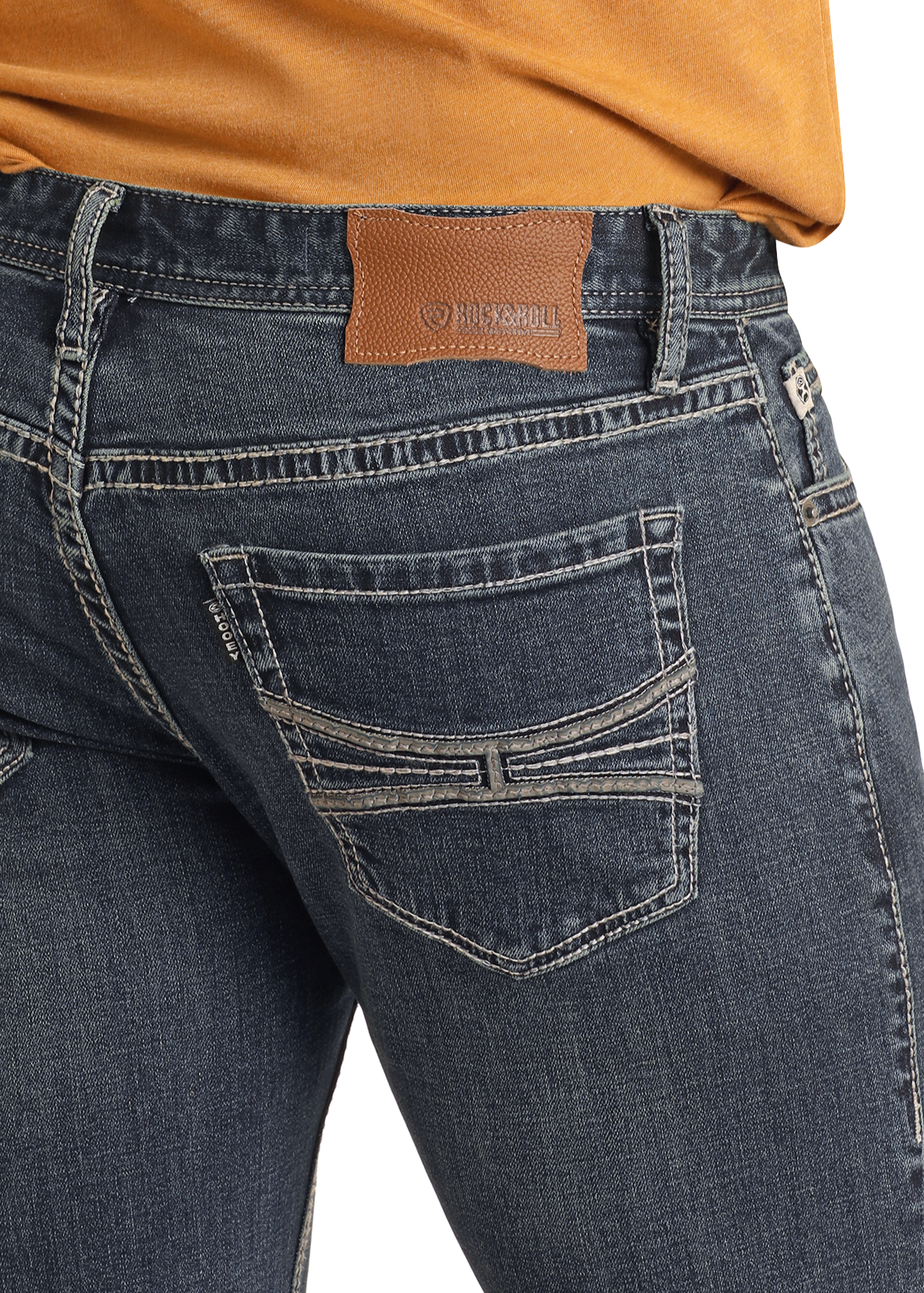 Close-up of a person wearing Rock & Roll Denim Hooey Slim Fit Grey Stitch Straight Leg Jeans, featuring detailed stitching and a brown leather patch on the waistband, paired with a mustard top. Only waist and upper legs are visible.