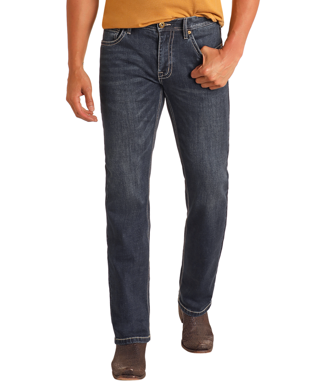 A person wearing Rock & Roll Denim Hooey Slim Fit Barbed Stitch Straight Leg Jeans in dark blue, a mustard yellow shirt, and brown boots stands with one hand in their pocket against a plain white background.