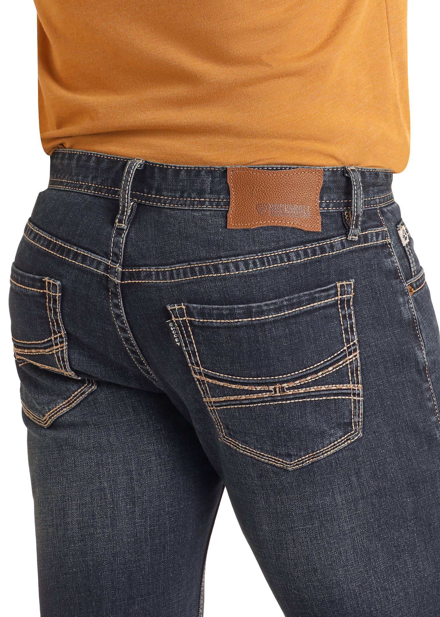 A person wears Hooey Slim Fit Barbed Stitch Straight Leg Jeans by Rock & Roll Denim, featuring beige stitching and a brown leather patch, paired with an orange shirt. The focus is on the stylish stretch jeans’ back pockets and upper area.