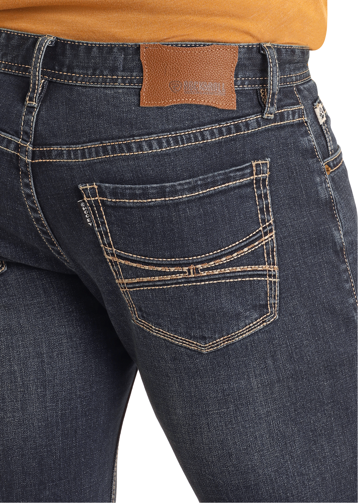 A person wears Hooey Slim Fit Barbed Stitch Straight Leg Jeans by Rock & Roll Denim, featuring beige stitching and a brown leather patch, paired with an orange shirt. The focus is on the stylish stretch jeans’ back pockets and upper area.