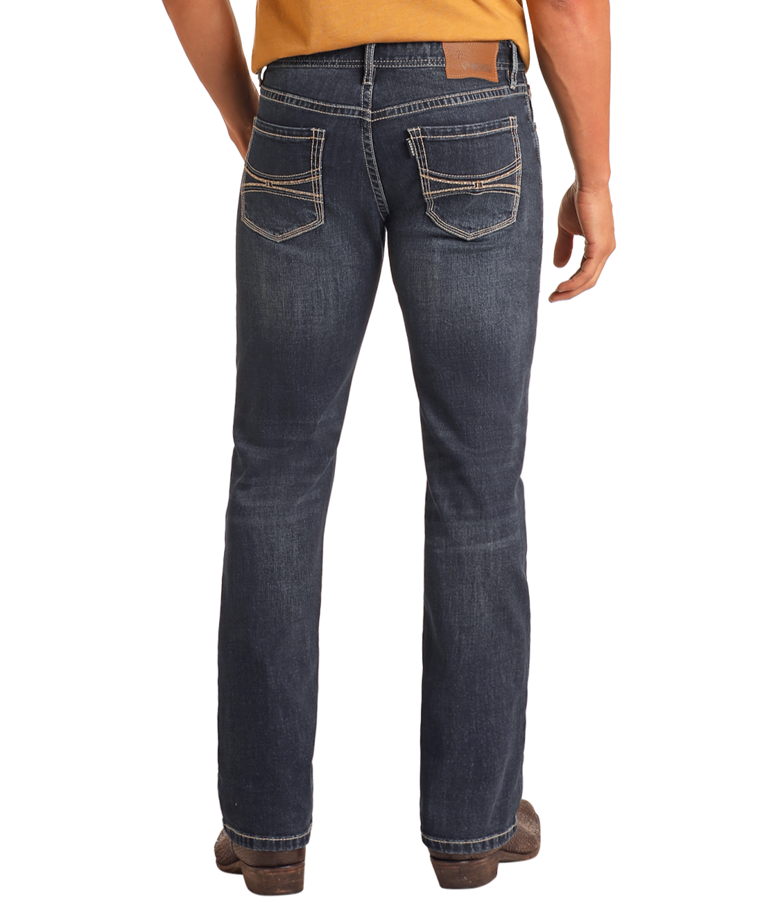 A person is shown from the back wearing a mustard yellow shirt, brown shoes, and Hooey Slim Fit Barbed Stitch Straight Leg Jeans by Rock & Roll Denim in dark blue with prominent white stitching.