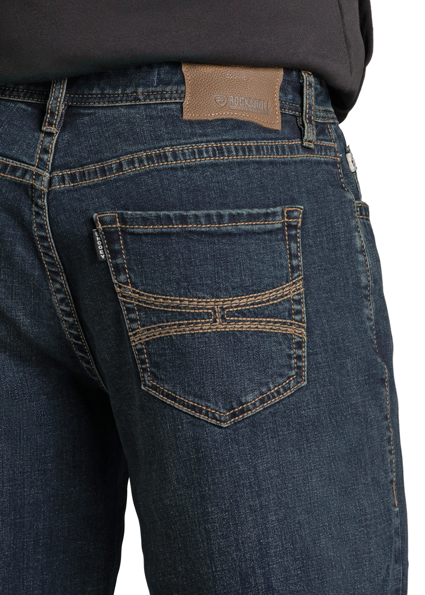 A person wearing Rock & Roll Denim Hooey Relaxed Fit Feather Stitch Pocket Stackable Bootcut Jeans with detailed back pocket stitching and a brown leather patch, paired with a black shirt.