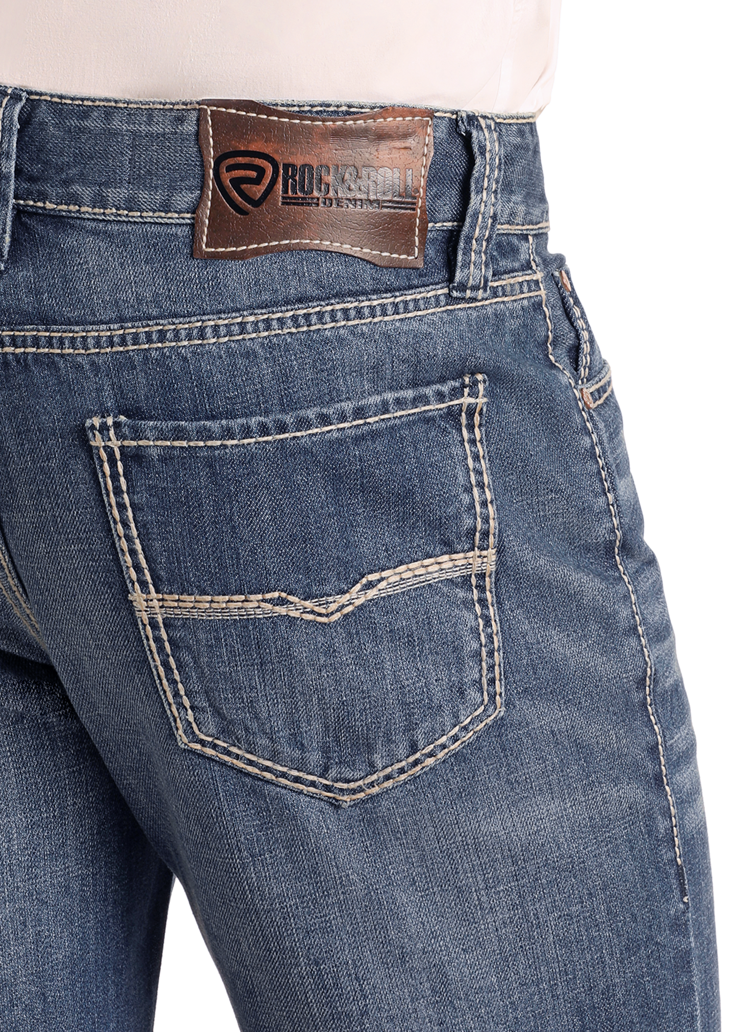 Close-up of the back of Relaxed Fit Medium Wash Straight Leg Jeans by Rock & Roll Denim, featuring tan stitching, two back pockets, and a brown leather brand patch on the waistband. The person wears a light shirt tucked in.