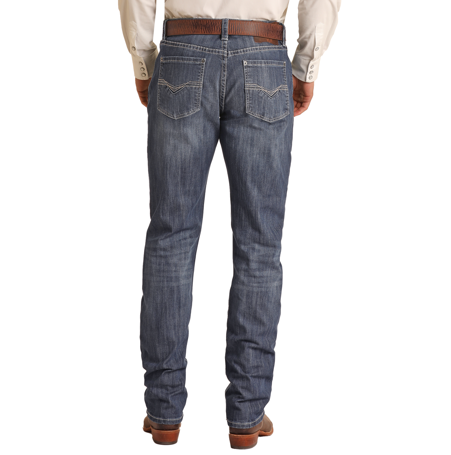 A person wearing a brown belt, light shirt, and brown shoes models Rock & Roll Denim Relaxed Fit Dark Wash Stackable Bootcut Jeans with decorative stitched back pockets, shown from the back against a plain white background.